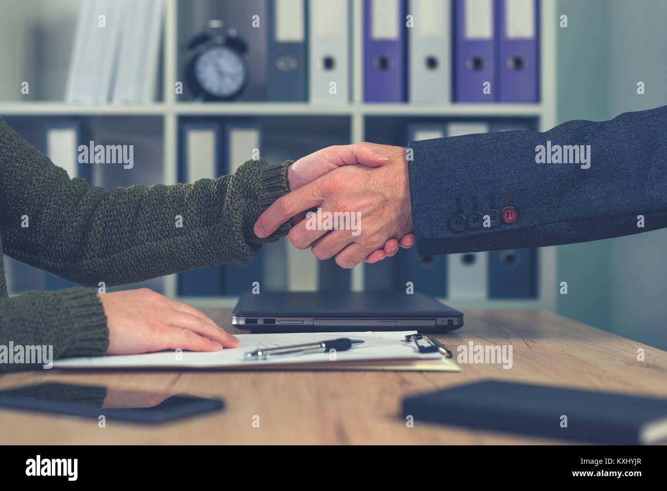 Man and woman shake hands over business agreement. Start up business female entrepreneur making handshake deal with large corporate company Stock Photo