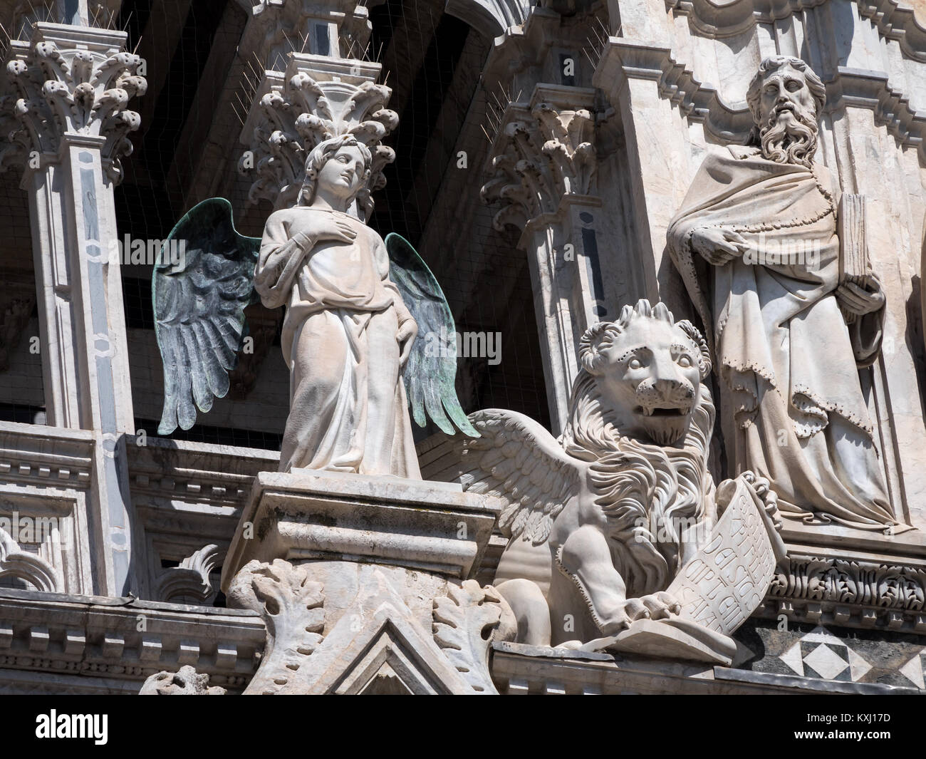 Statues of angel, lion and philosopher at Siena Cathedral Stock Photo