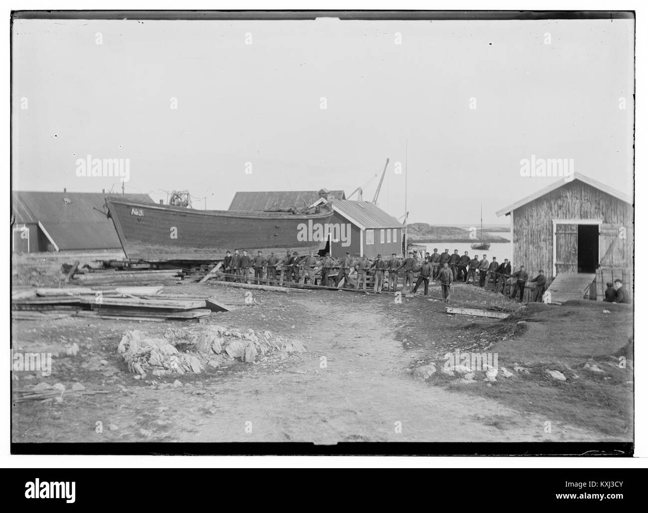 A photograph showing a laboring crew using a pram in Andenes, Norway ...