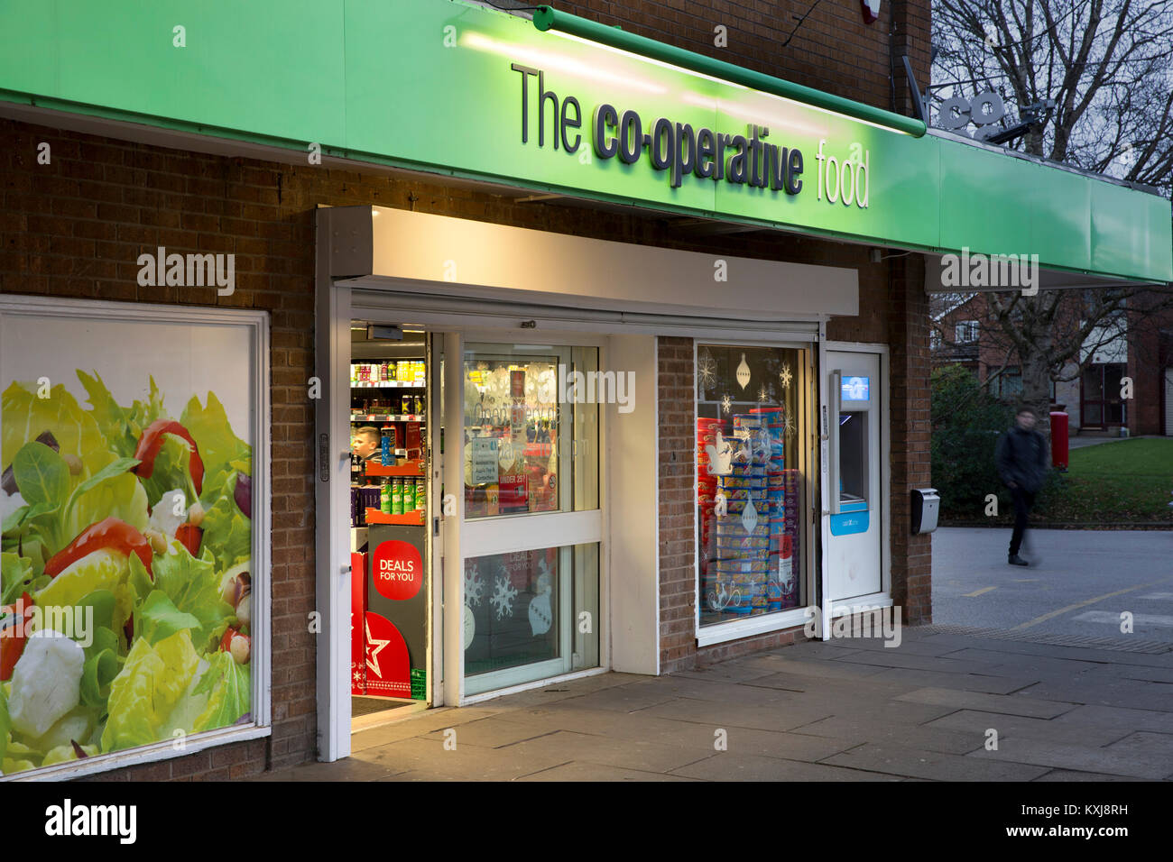 UK, England, Cheshire, Stockport, Bramhall, Dairyground Road, Co-op food store entrance at dusk Stock Photo
