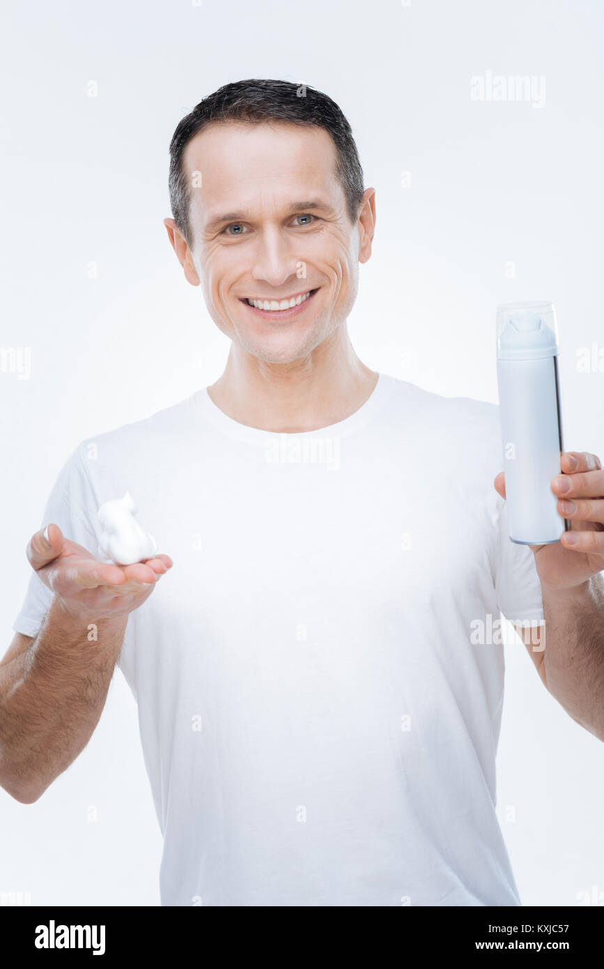 Nice happy man having shaving foam in his hands Stock Photo Alamy