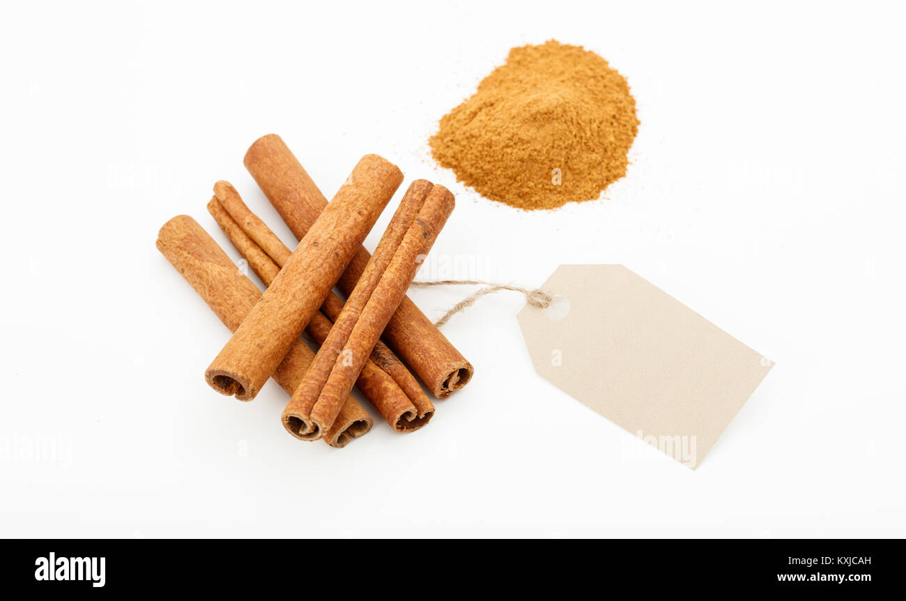 Cinammon sticks and powder with label on a white background Stock Photo