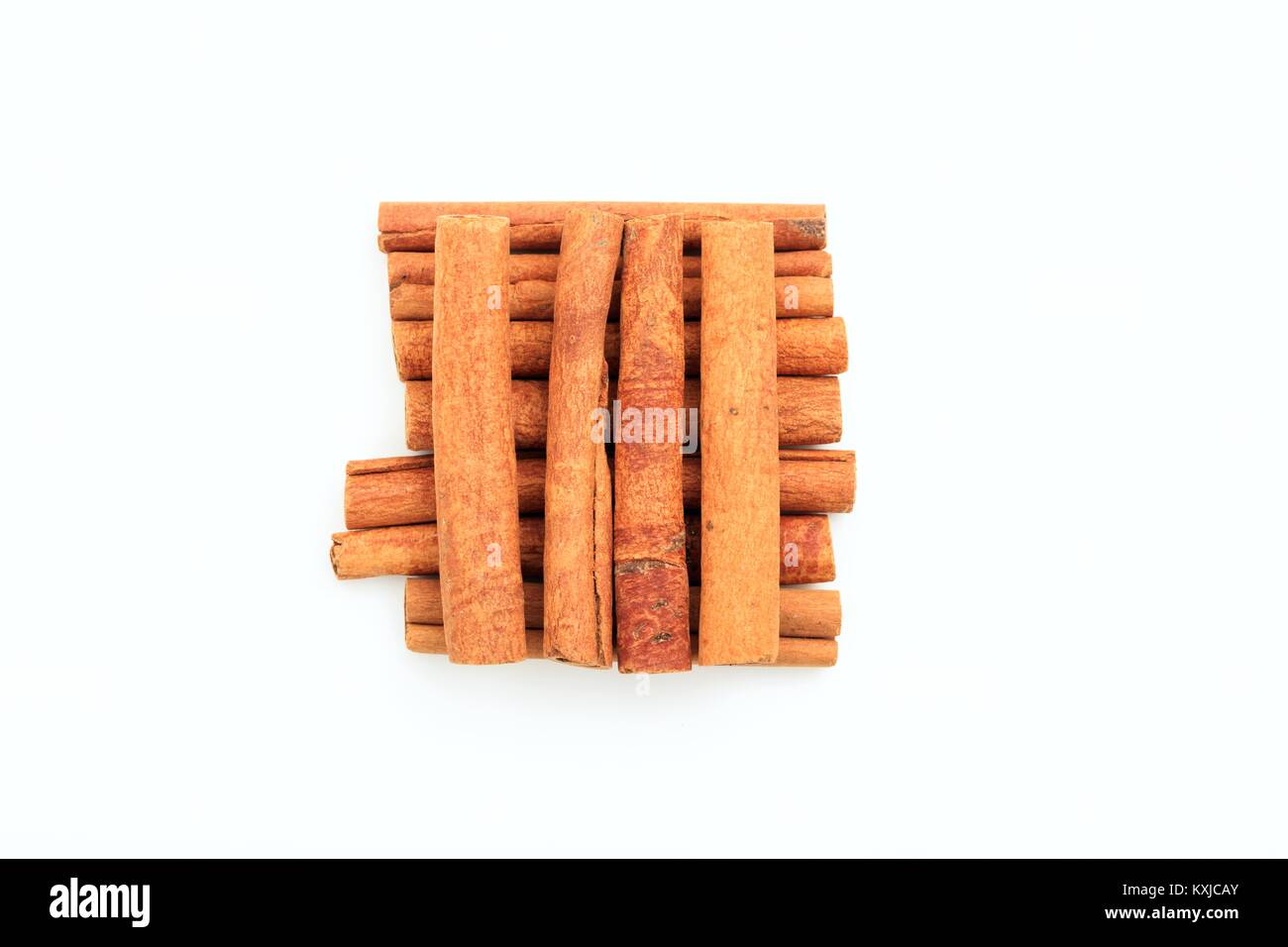 Cinnamon sticks in a square shape, on white background Stock Photo