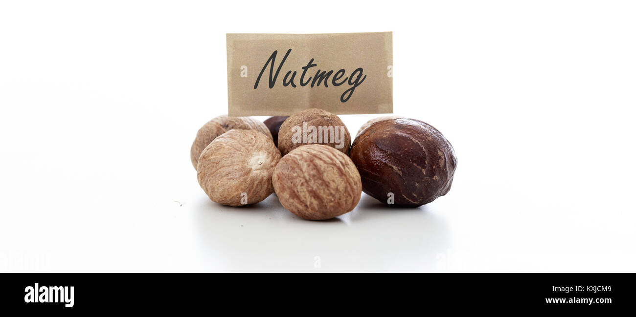 Nutmeg seeds on white background Stock Photo