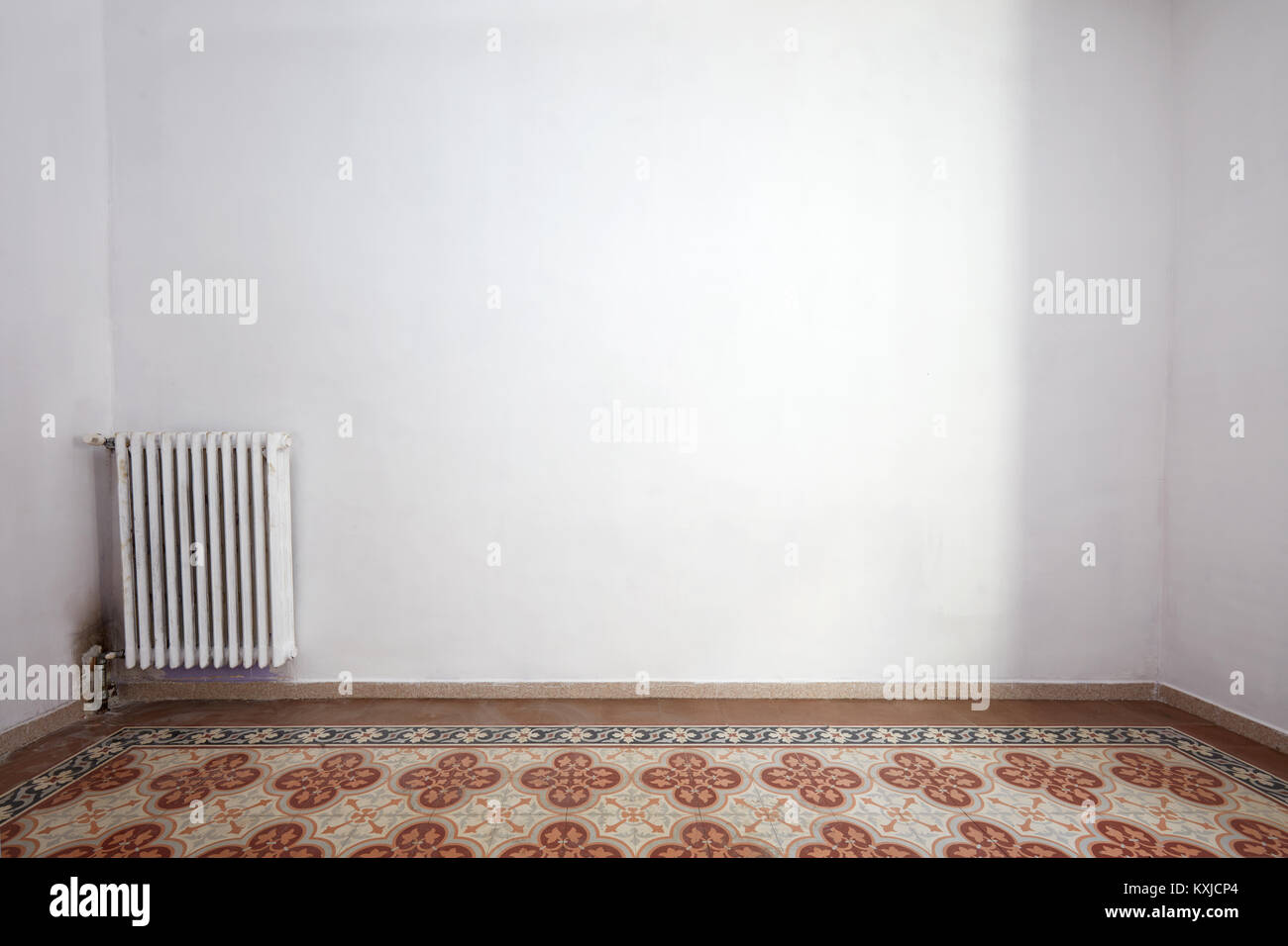 Empty room interior with tiled floor and white wall Stock Photo