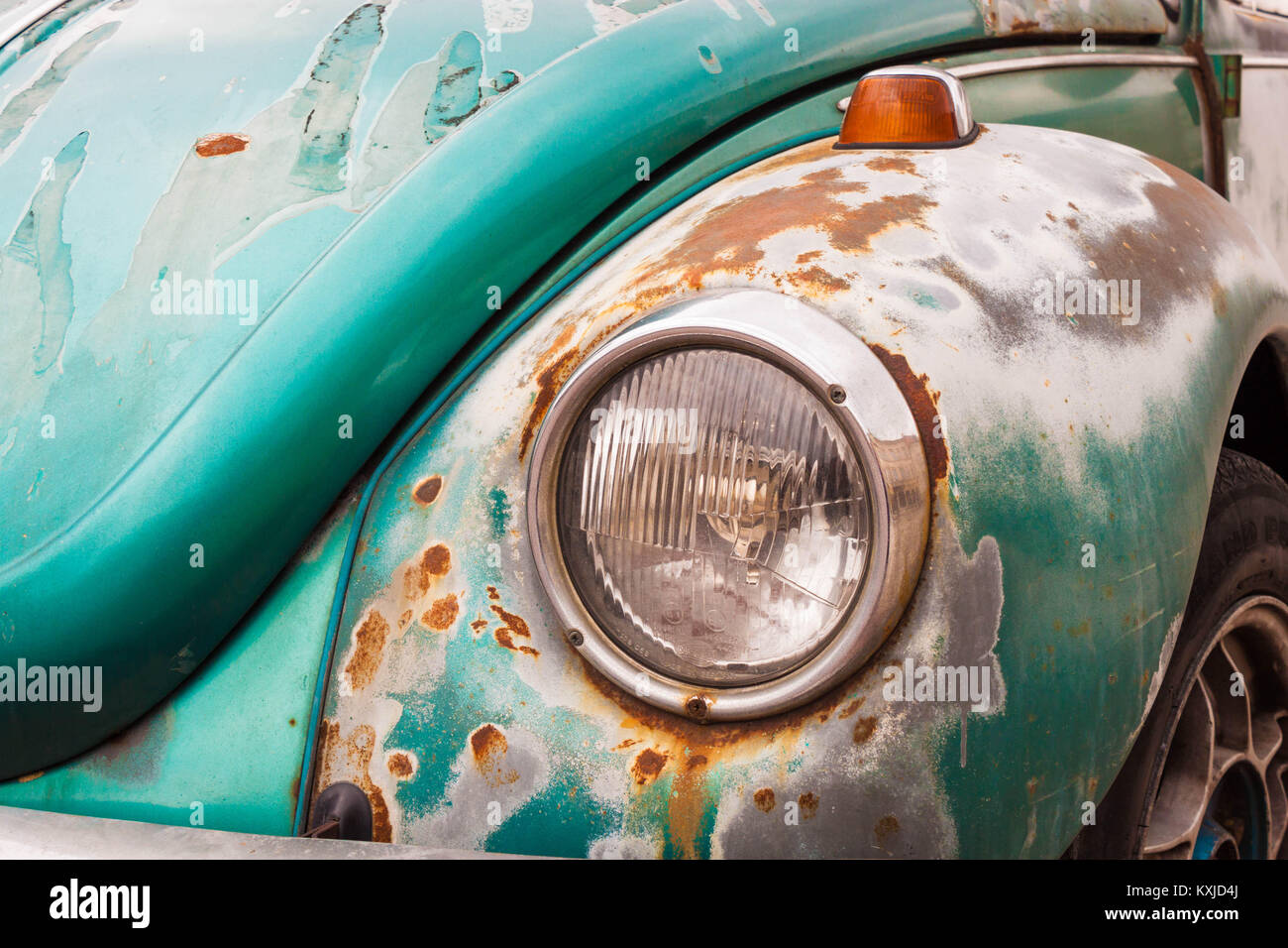 Warsaw, Poland - February 23, 2017: Old vintage car bumper with headlight closeup. Turquoise peeled paint and rusty metal. Antique oldtimer Stock Photo