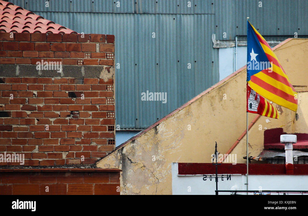 Buildings with flag of catalonia waving in the wind (estelada), Barcelona, Catalonia, Spain. Stock Photo