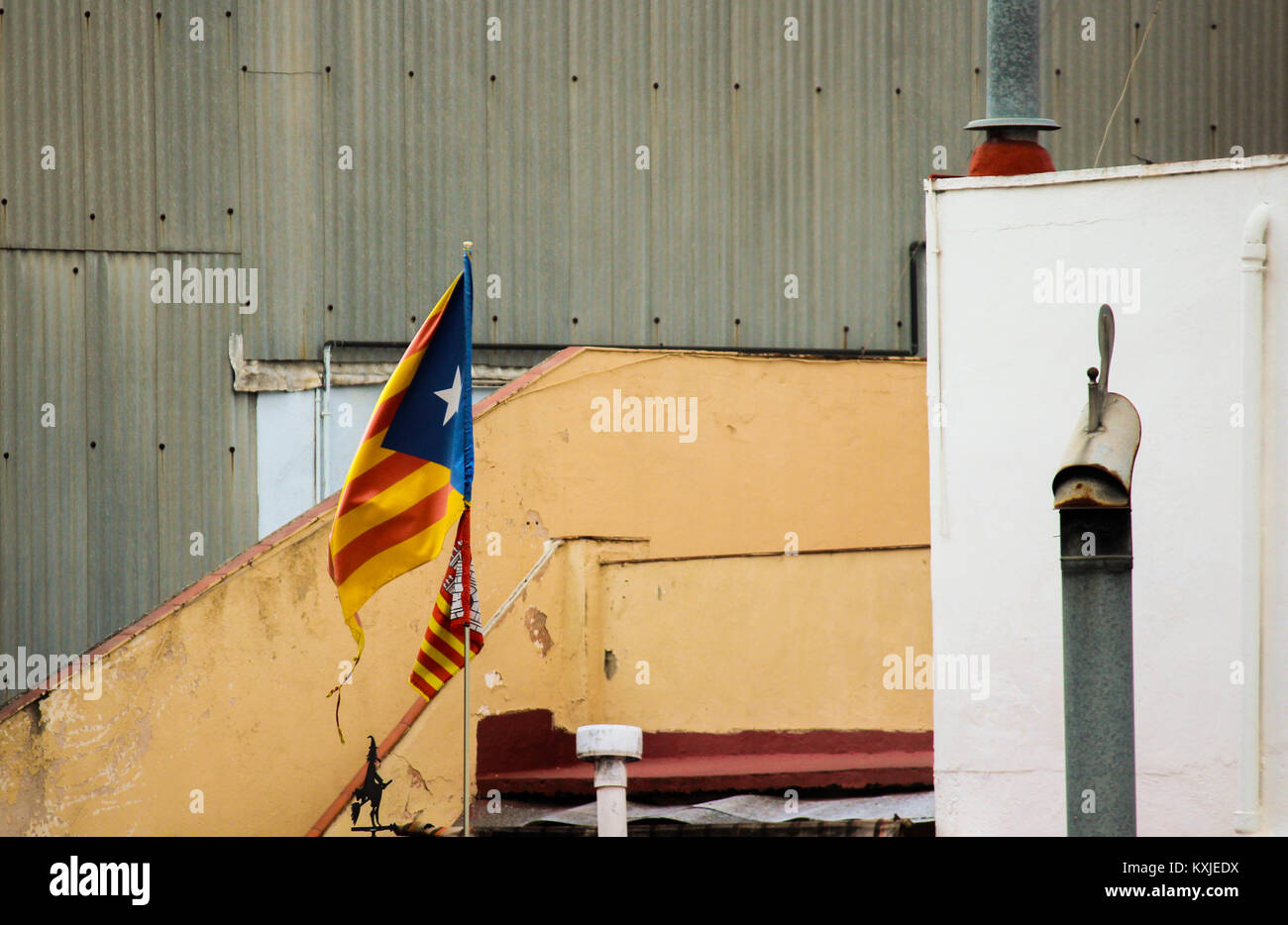 Buildings with flag of catalonia waving in the wind (estelada), Barcelona, Catalonia, Spain. Stock Photo