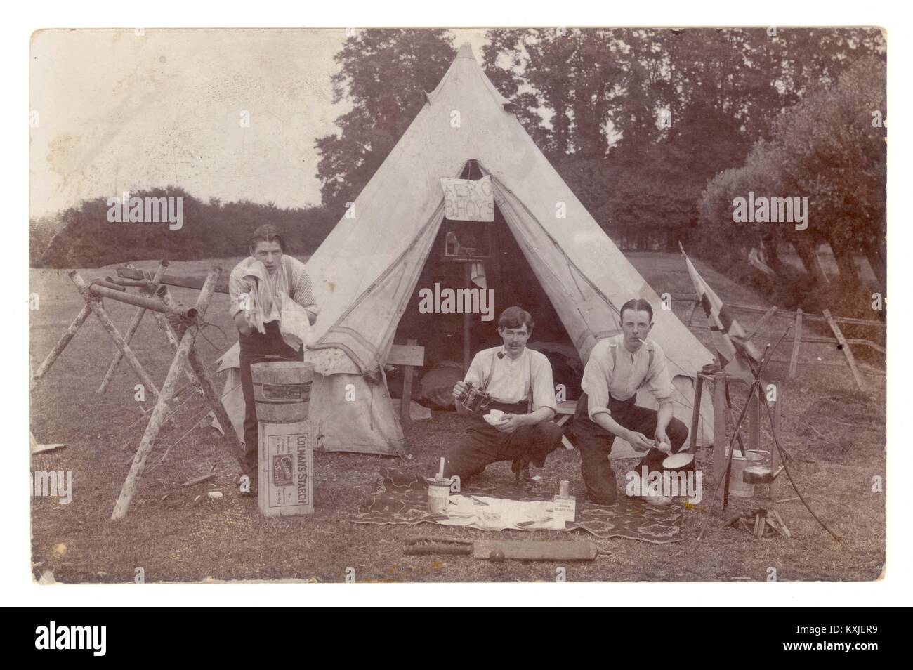 Early WW1 era postcard of young men camping, Aero Bhoys sign in the tent, possibly young aviators from Brooklands Aero Club, Surrey or camp nickname or just young men having fun, circa 1914 Stock Photo