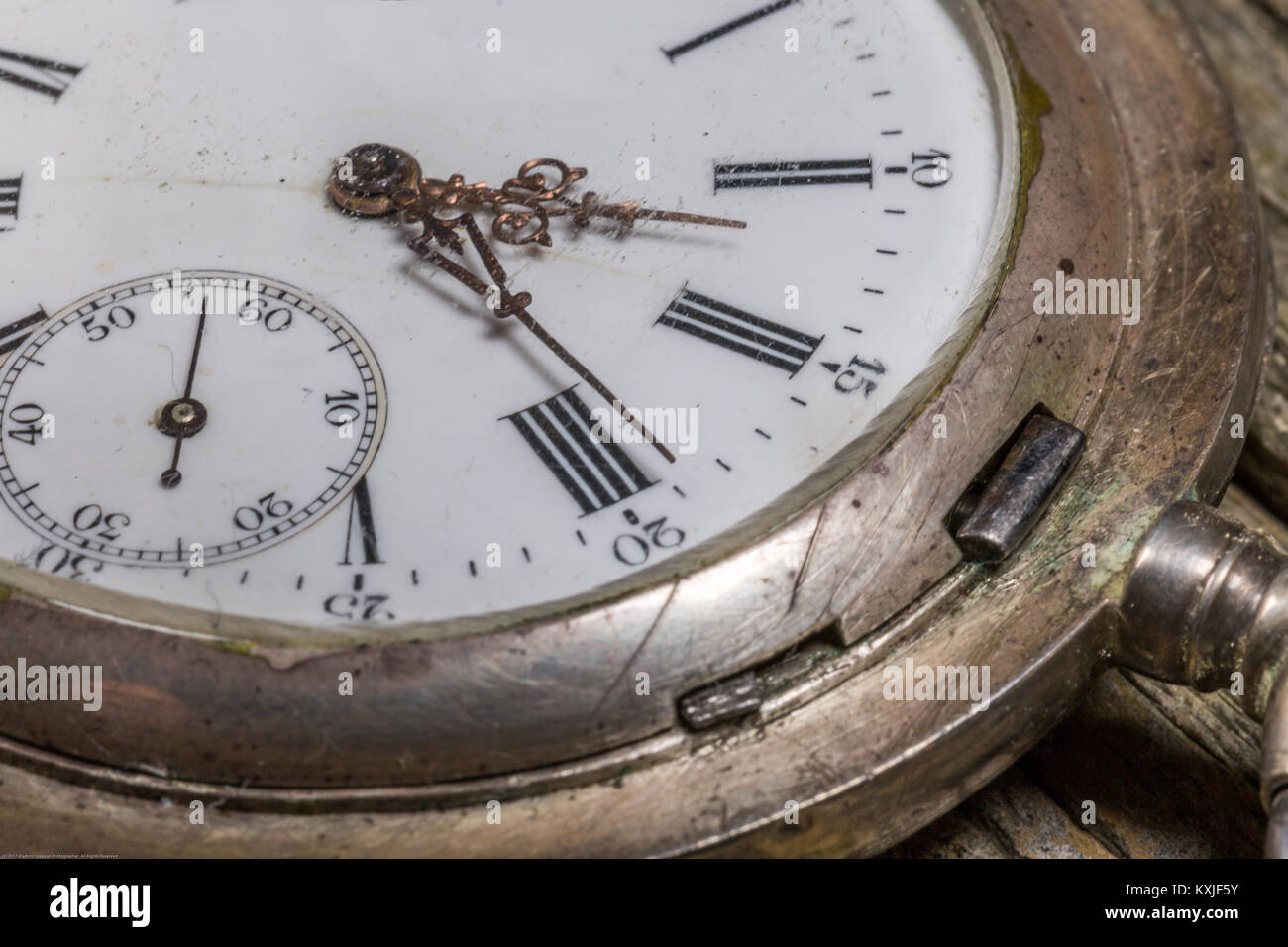 Close-Up image of antique pocket watch on wooden table Stock Photo