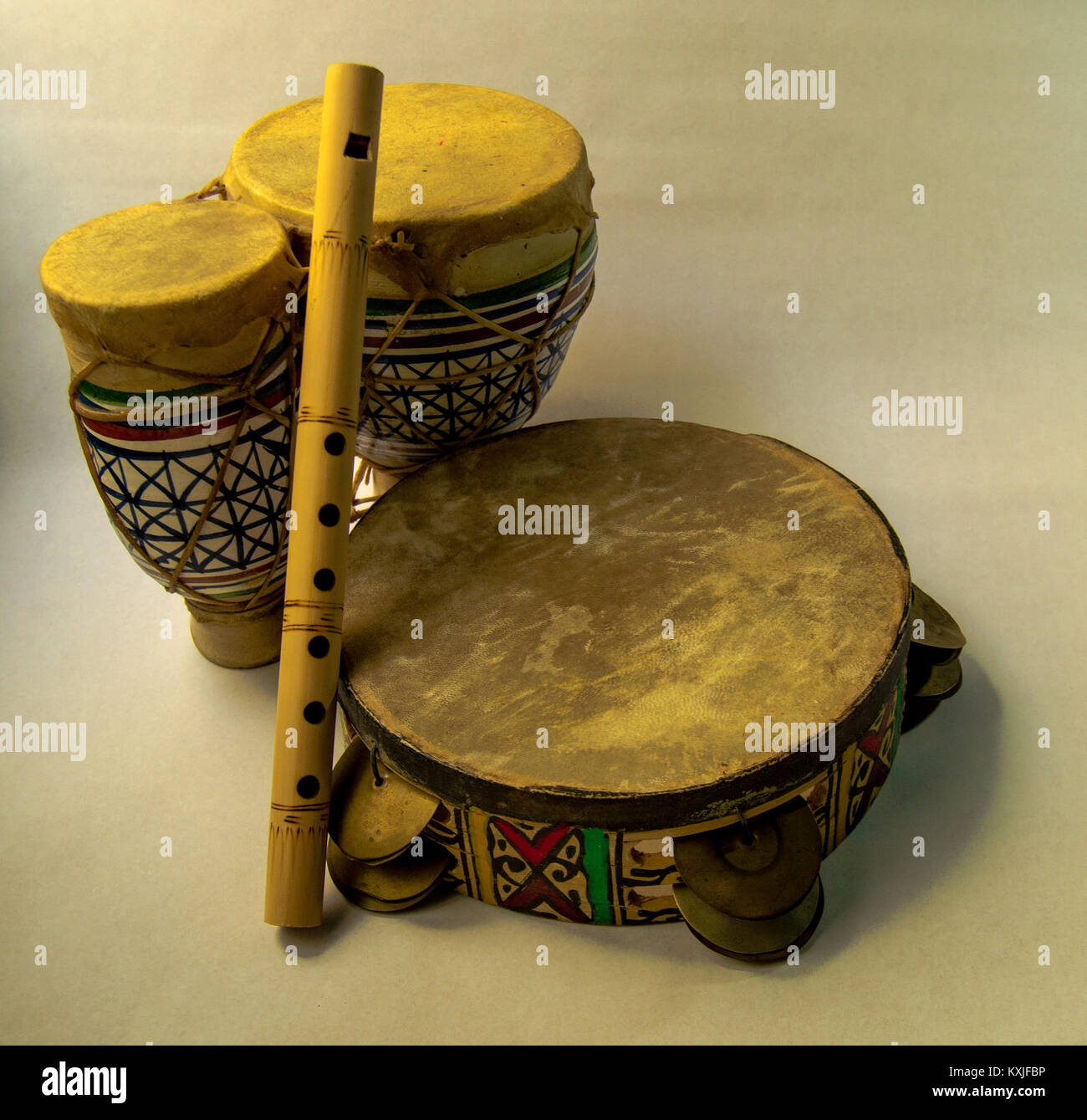 Ethnic instruments: drum, flute and tambourine on white background ...