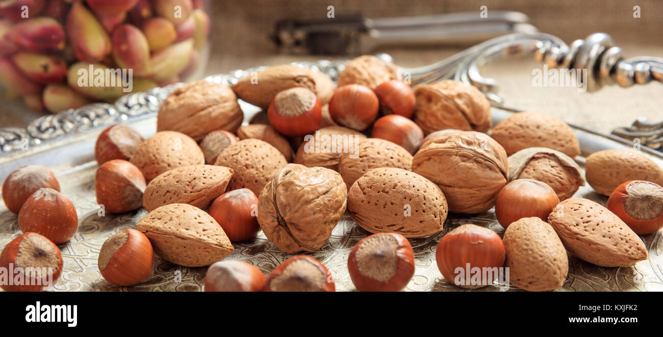 Almonds, walnuts and hazelnuts on a silver tray Stock Photo Alamy
