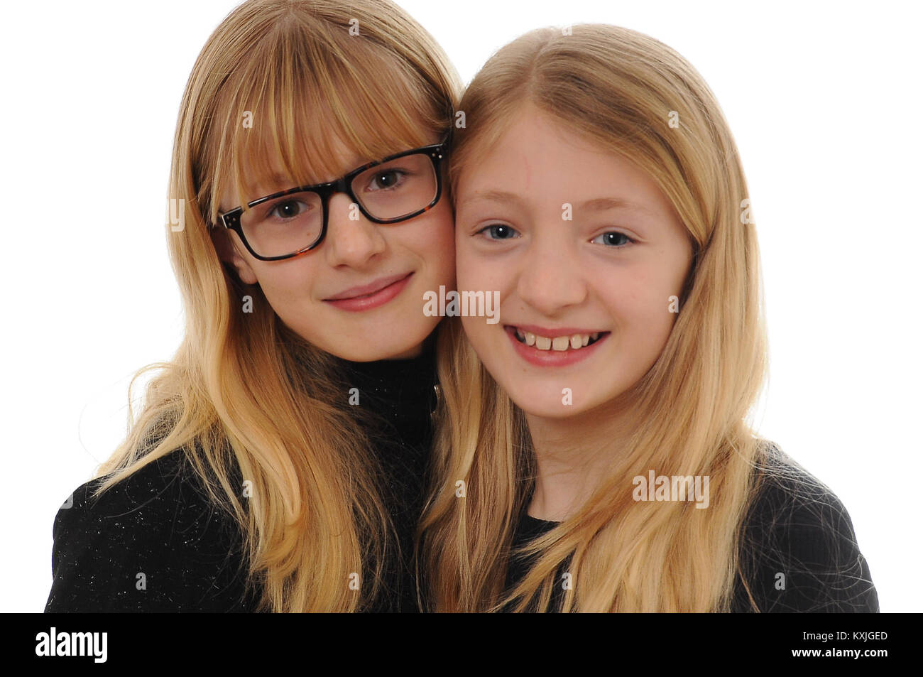 two pretty blonde Caucasian girls, smiling and hugging isolated on white Stock Photo