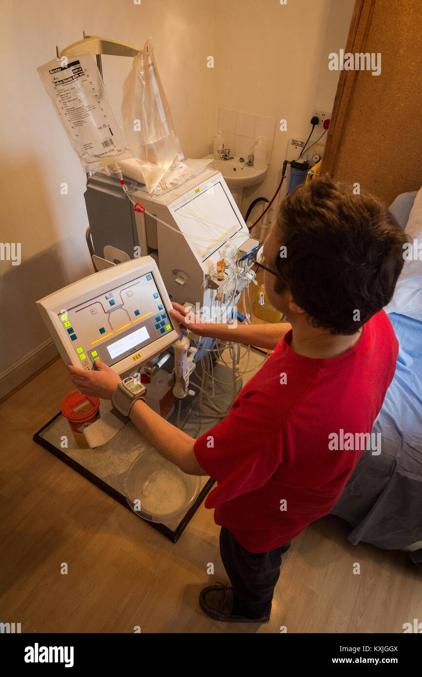 Home dialysis - mum caring for her son UK Stock Photo
