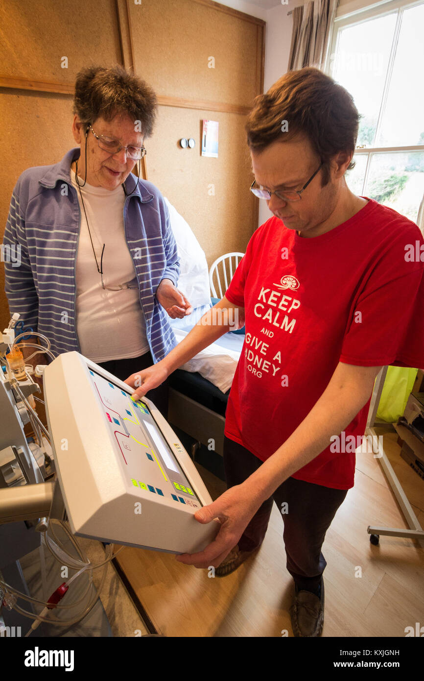 Home dialysis - mum caring for her son UK Stock Photo