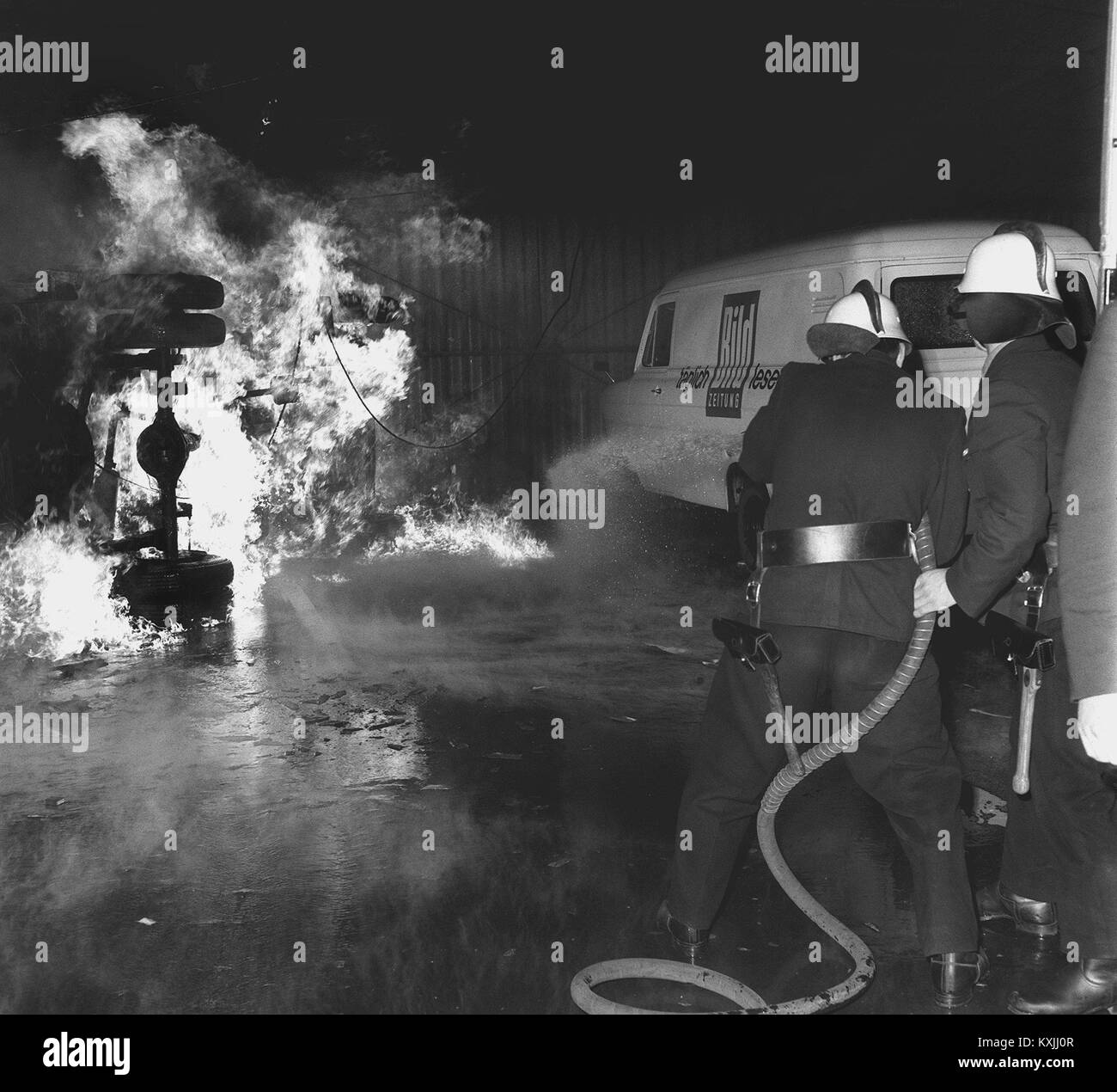Fire rescuers extinguish a fire after demonstrations on the occasion of the assassination attempt on Rudi Dutschke. | usage worldwide Stock Photo