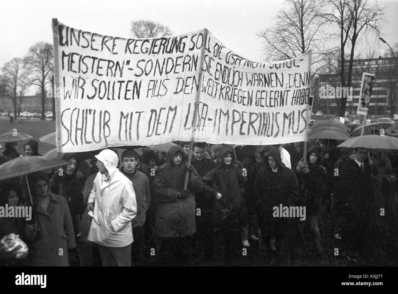 Despite the heavy rain, about 1,200 people gather at Moorweide in front of train station Dammtor in Hamburg to demonstrate against Vietnam War on 22 March 1968. | usage worldwide Stock Photo