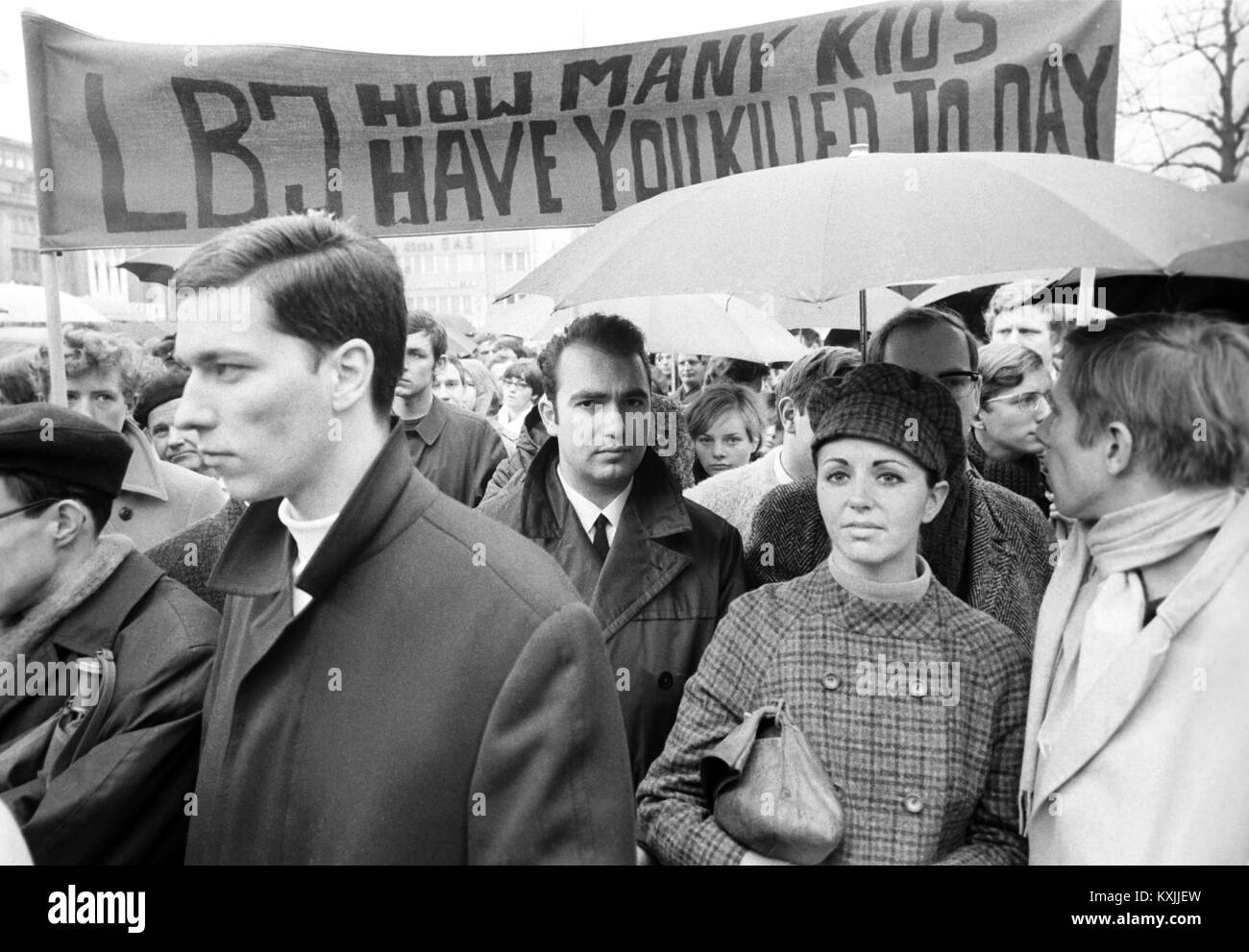 A banner asks US president Lyndon B. Johnson: 'L.B.J. How many kids have you killed today'. Around 1,000 people have gathered at Wittenbergplatz in Berlin to demonstrate against Vietnam War on 23 March 1968. | usage worldwide Stock Photo