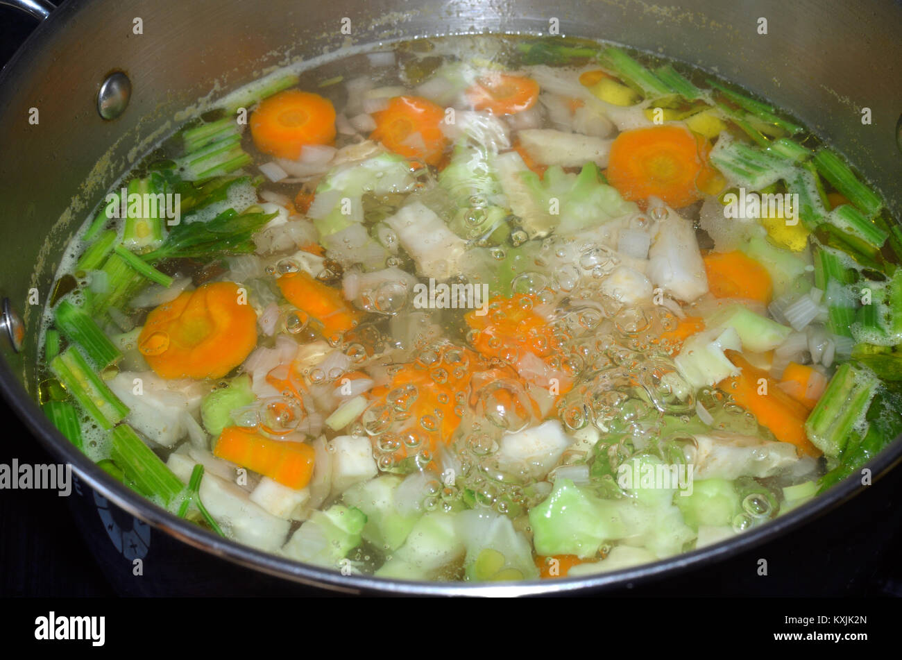 Pot with boiling water with fresh cut vegetables Stock Photo Alamy