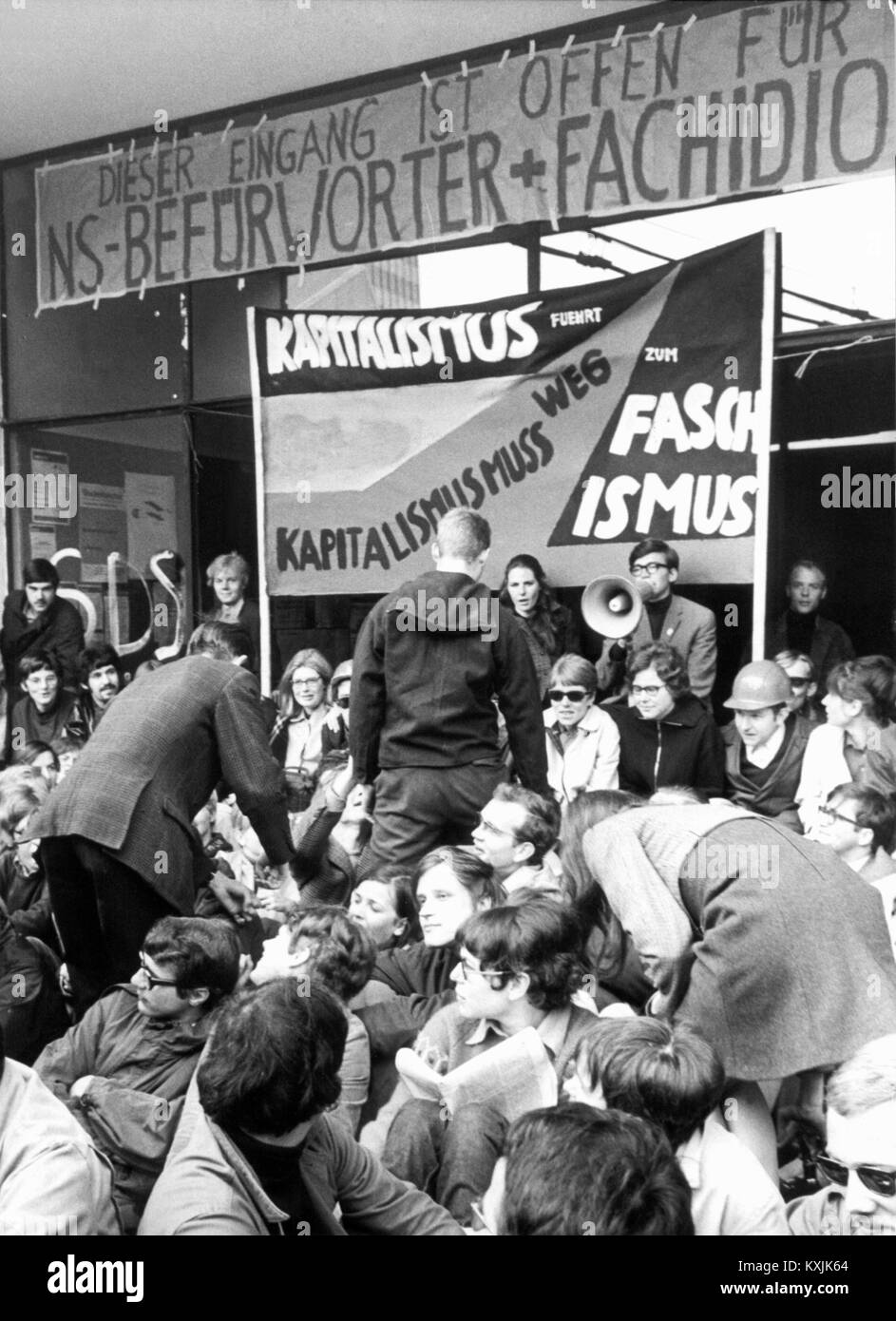 Students push through a group of fellow students, who block the main entrance of the Johann Wolfgang Goethe-University in Frankfurt with a 'Sit In' on the 24th of May in 1968. | usage worldwide Stock Photo