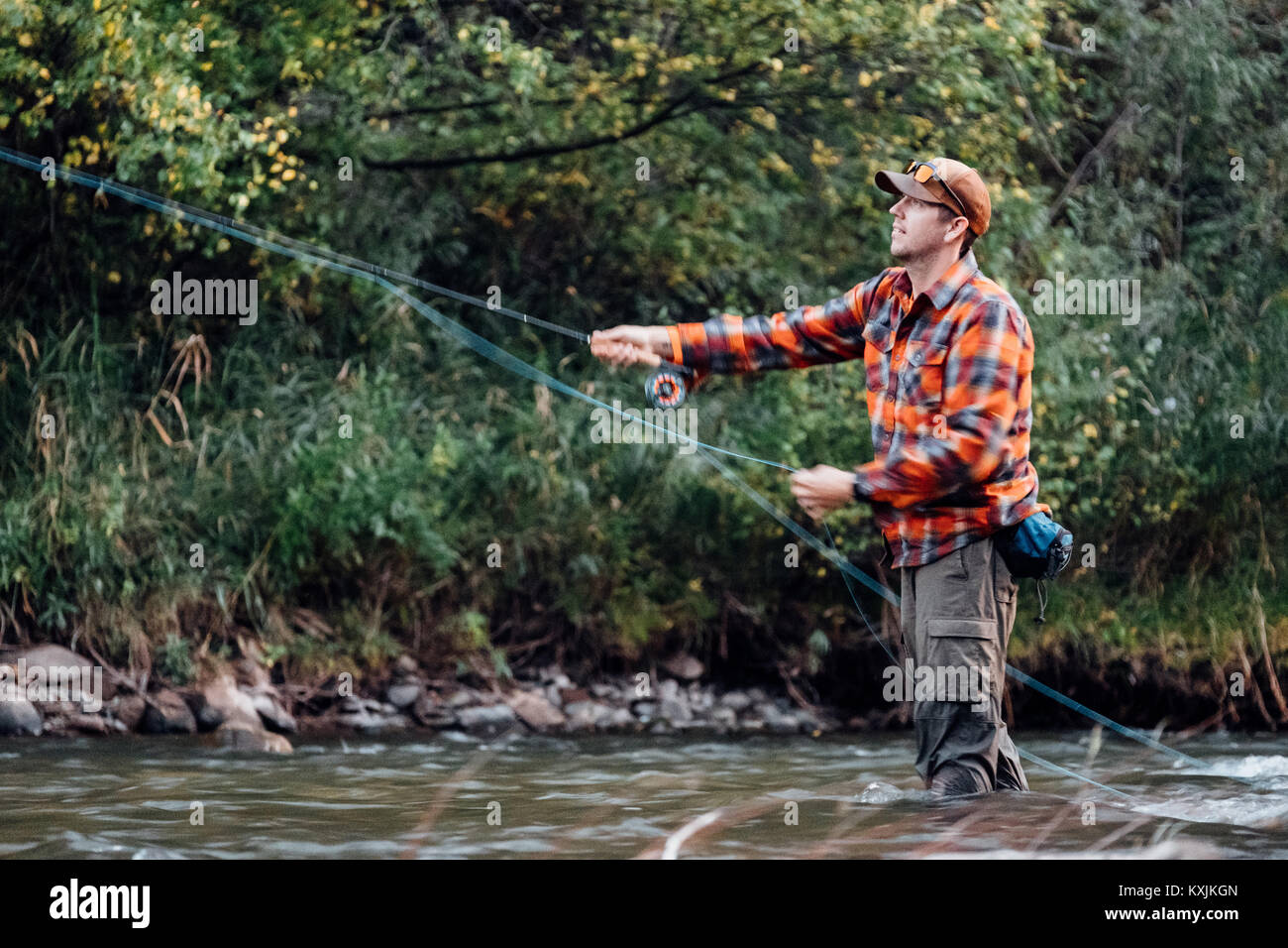 Man wading in river, fishing Stock Photo Alamy