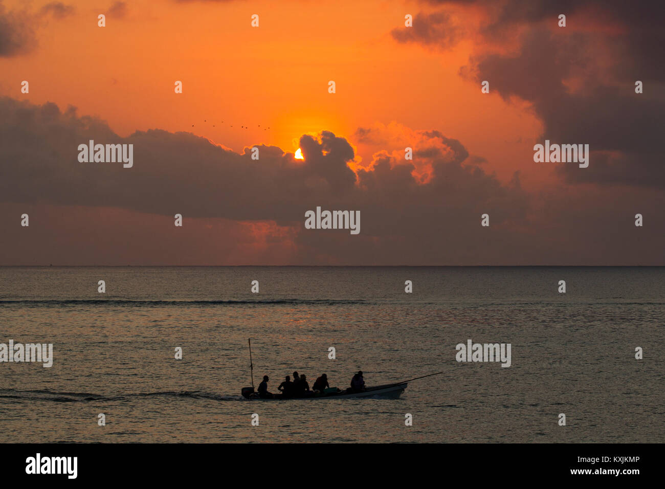 Seascape with silhouetted fishing boat at sunset, Zanzibar,Tanzania, Africa Stock Photo