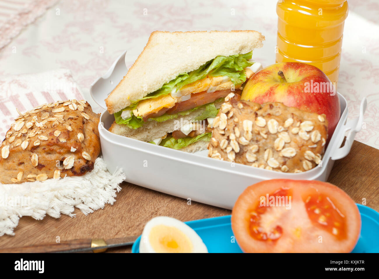 Lunchbox on the morning breakfast table with sandwiches Stock Photo