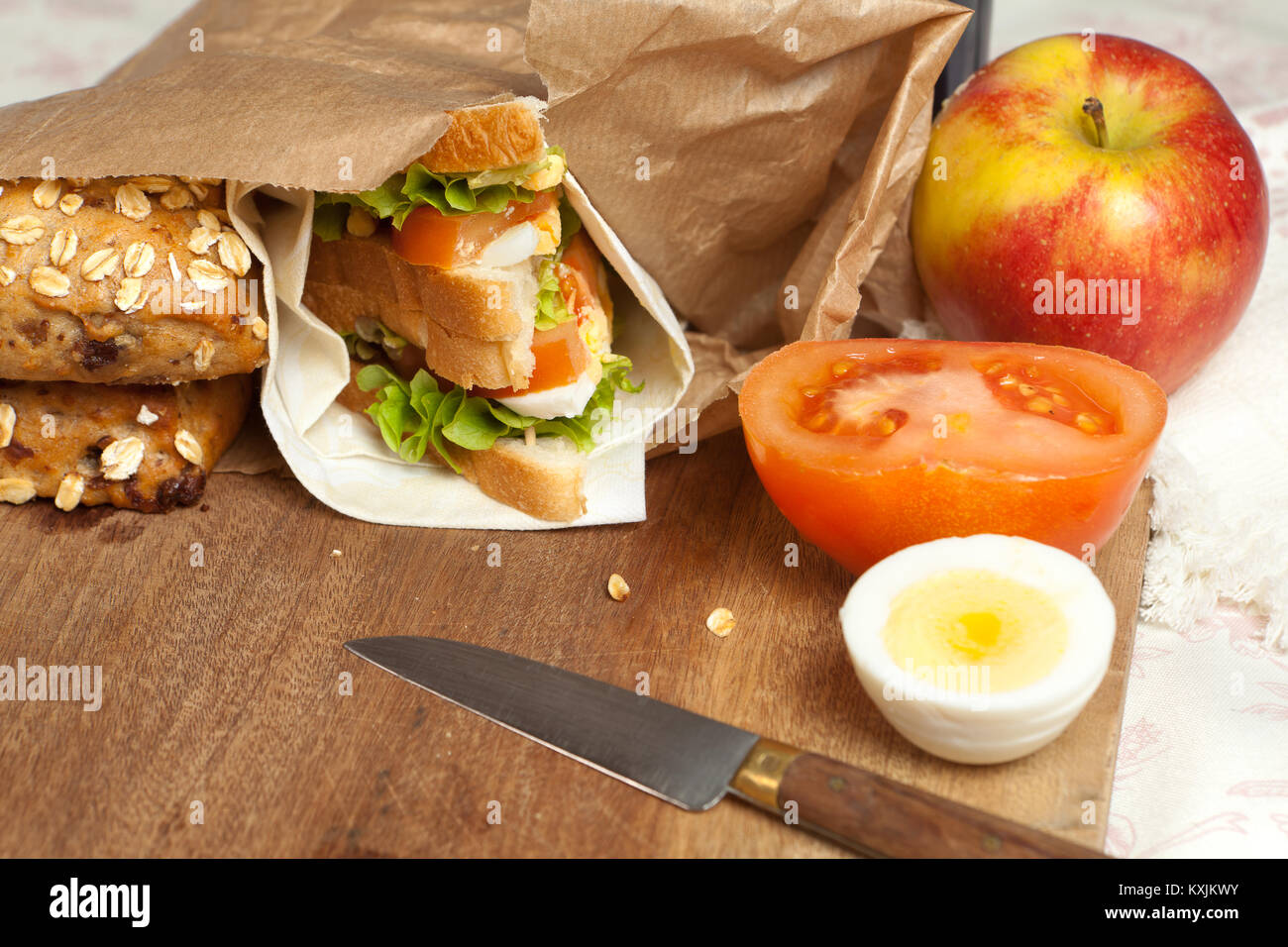 Brown paper bag with sandwich and apple for lunch Stock Photo