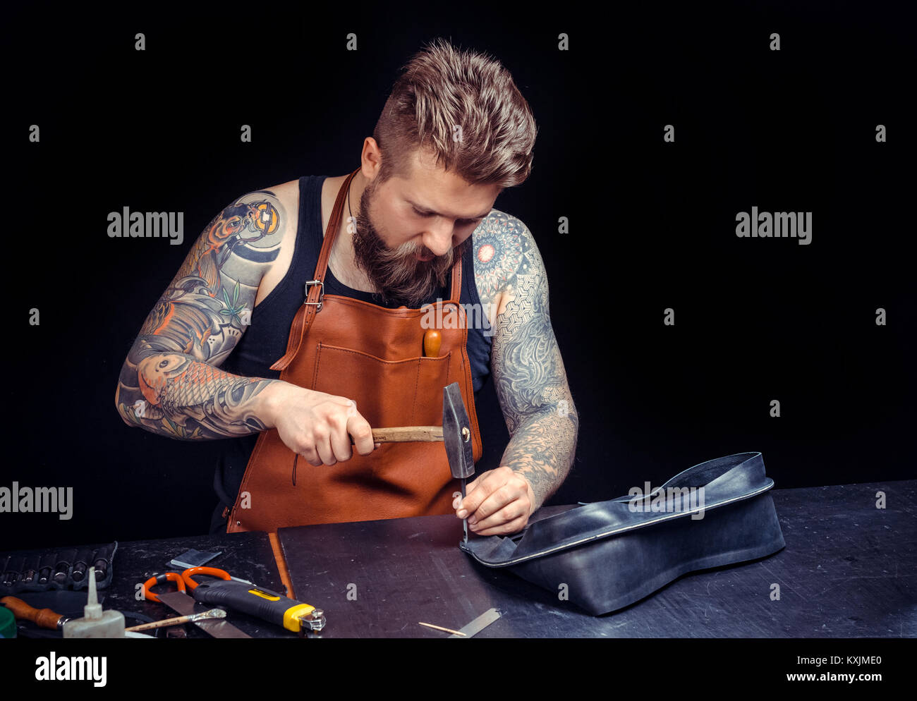 Leather Craftsman creates a new leatherwork at his shop Stock Photo Alamy