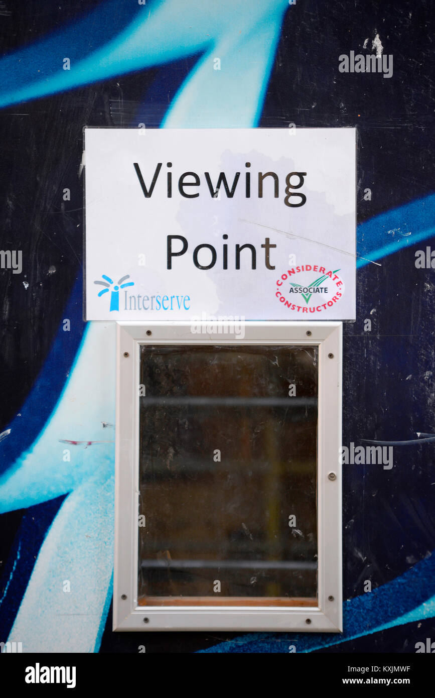 Building site construction viewing point window. Interserve Considerate constructors associate logo Stock Photo