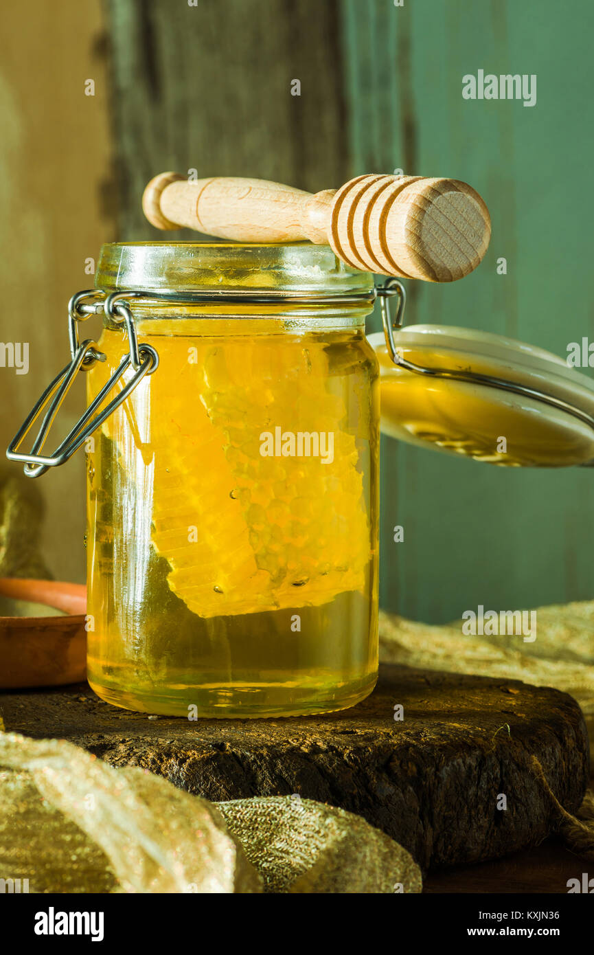 Honey in a jar with honey comb inside Stock Photo Alamy