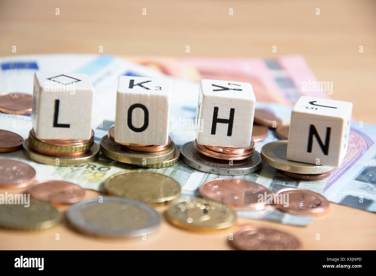Lohn ( german for salary ) word written on wood cube Stock Photo