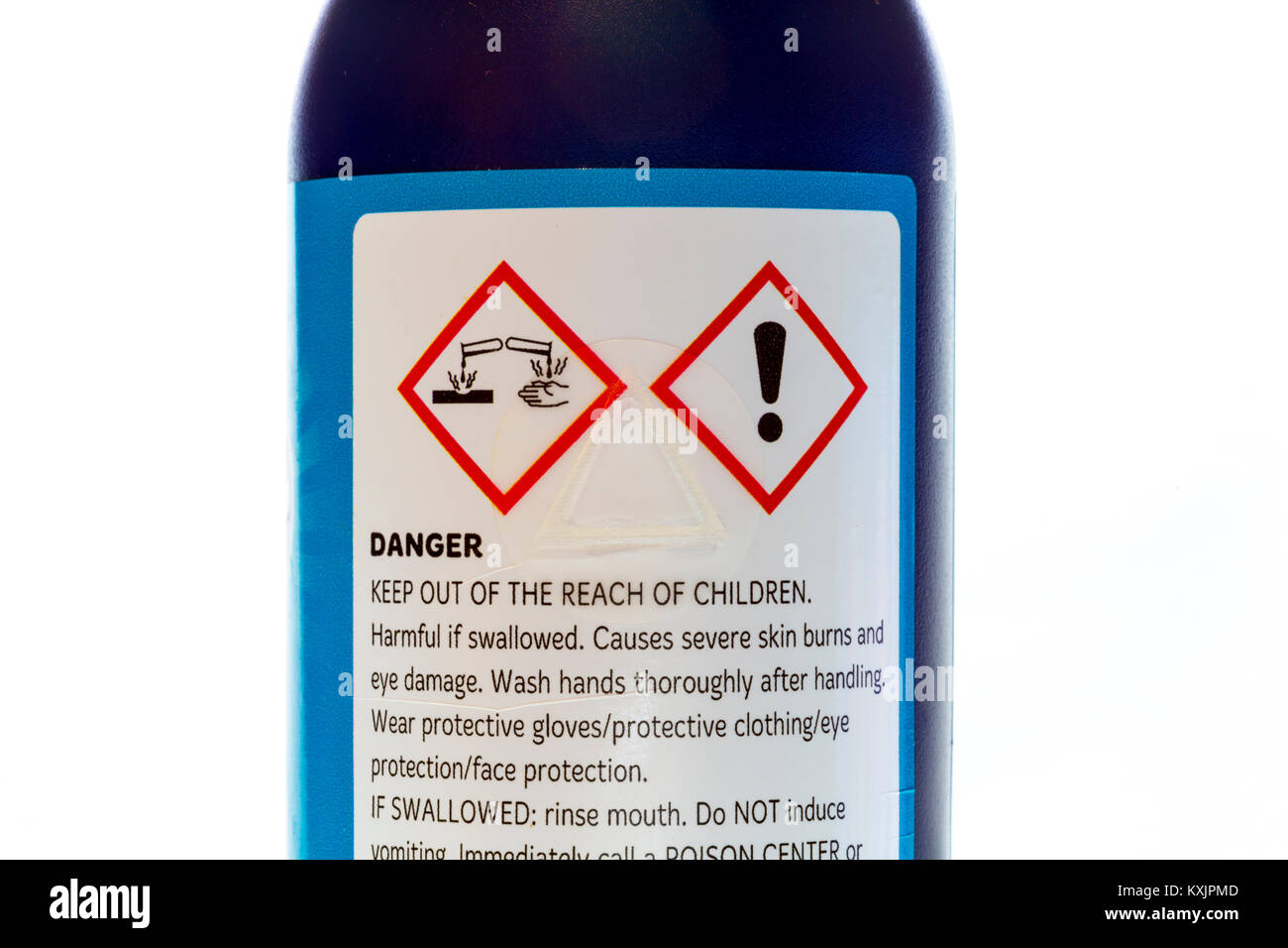 The international pictogram for corrosive chemicals. On a bottle of cleaner. Stock Photo