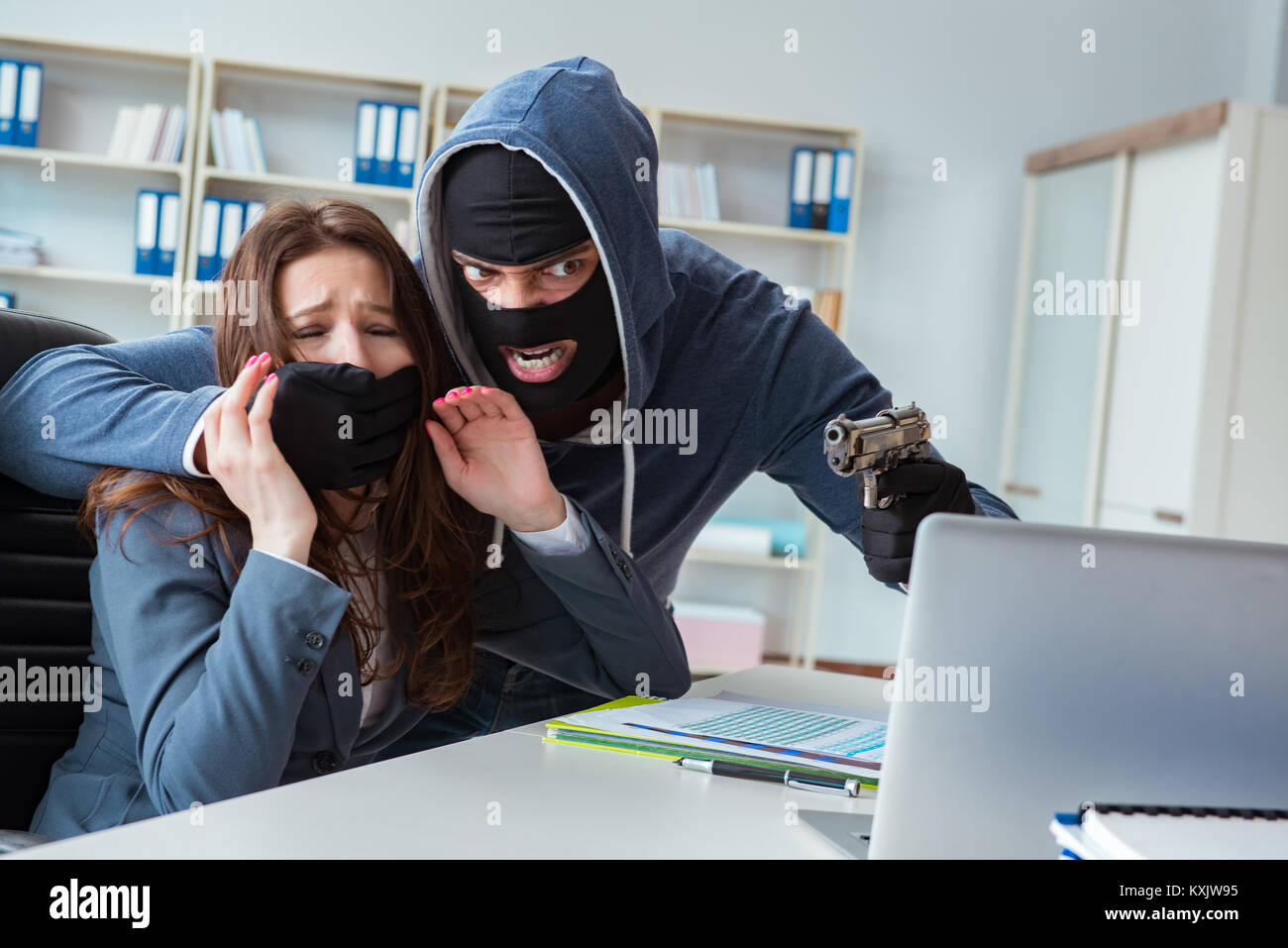 Criminal taking businesswoman as hostage in office Stock Photo - Alamy
