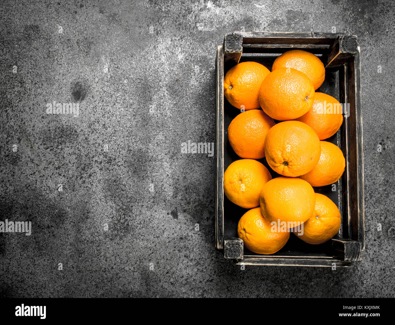 Fresh oranges in a box. On a rustic background Stock Photo - Alamy