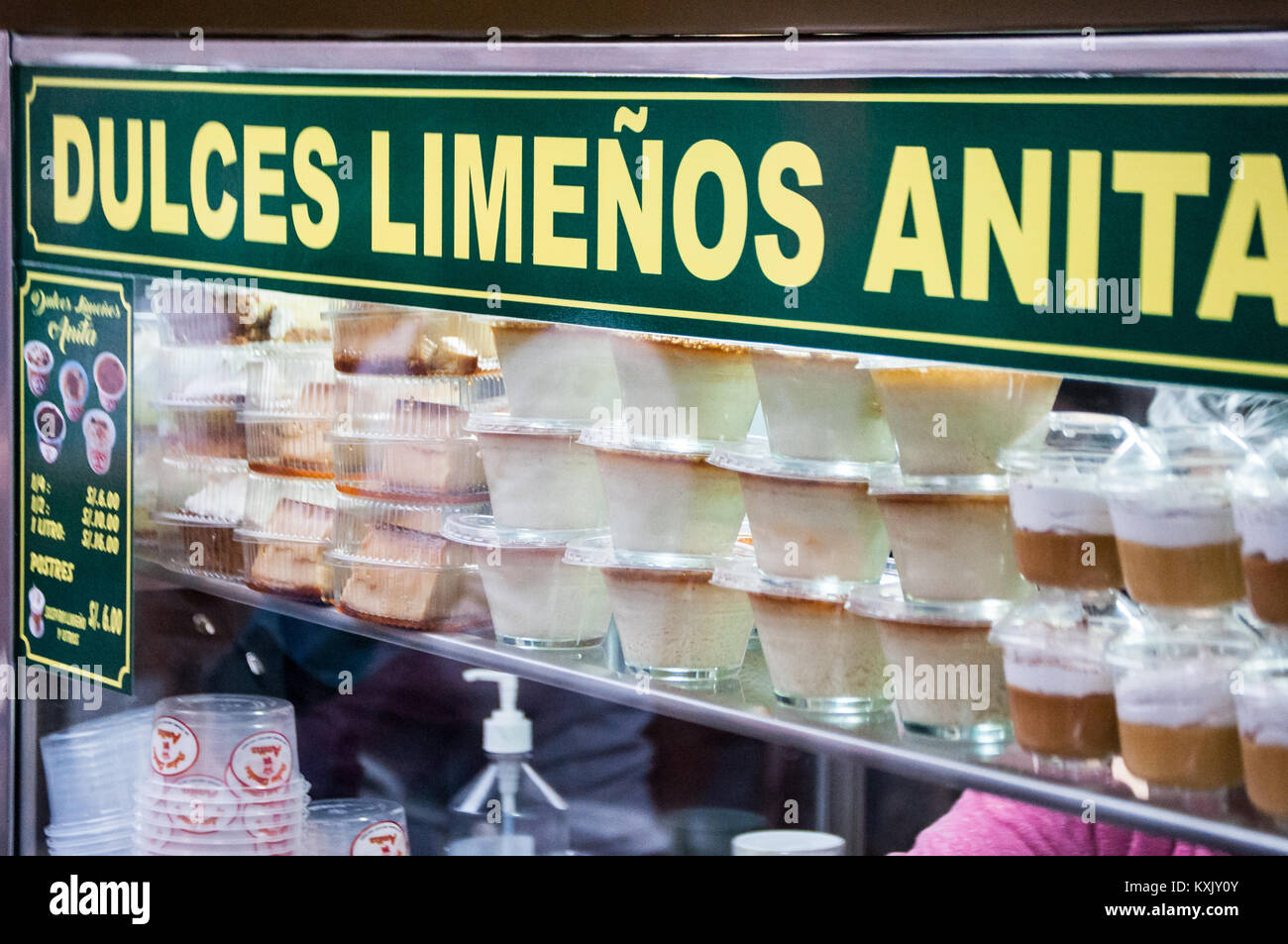Street food stall in Peru selling typical desserts from Lima including Suspiro de Limena a very sweet meringue and condensed milk treat. Stock Photo