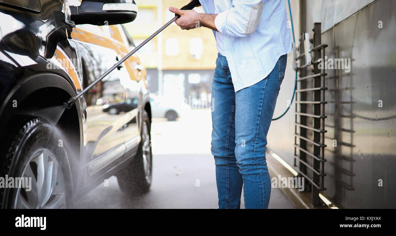 Manual car wash with pressurized water in car wash Stock Photo Alamy