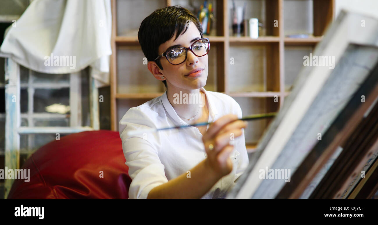Female artist painting with palette and paintbrush Stock Photo - Alamy