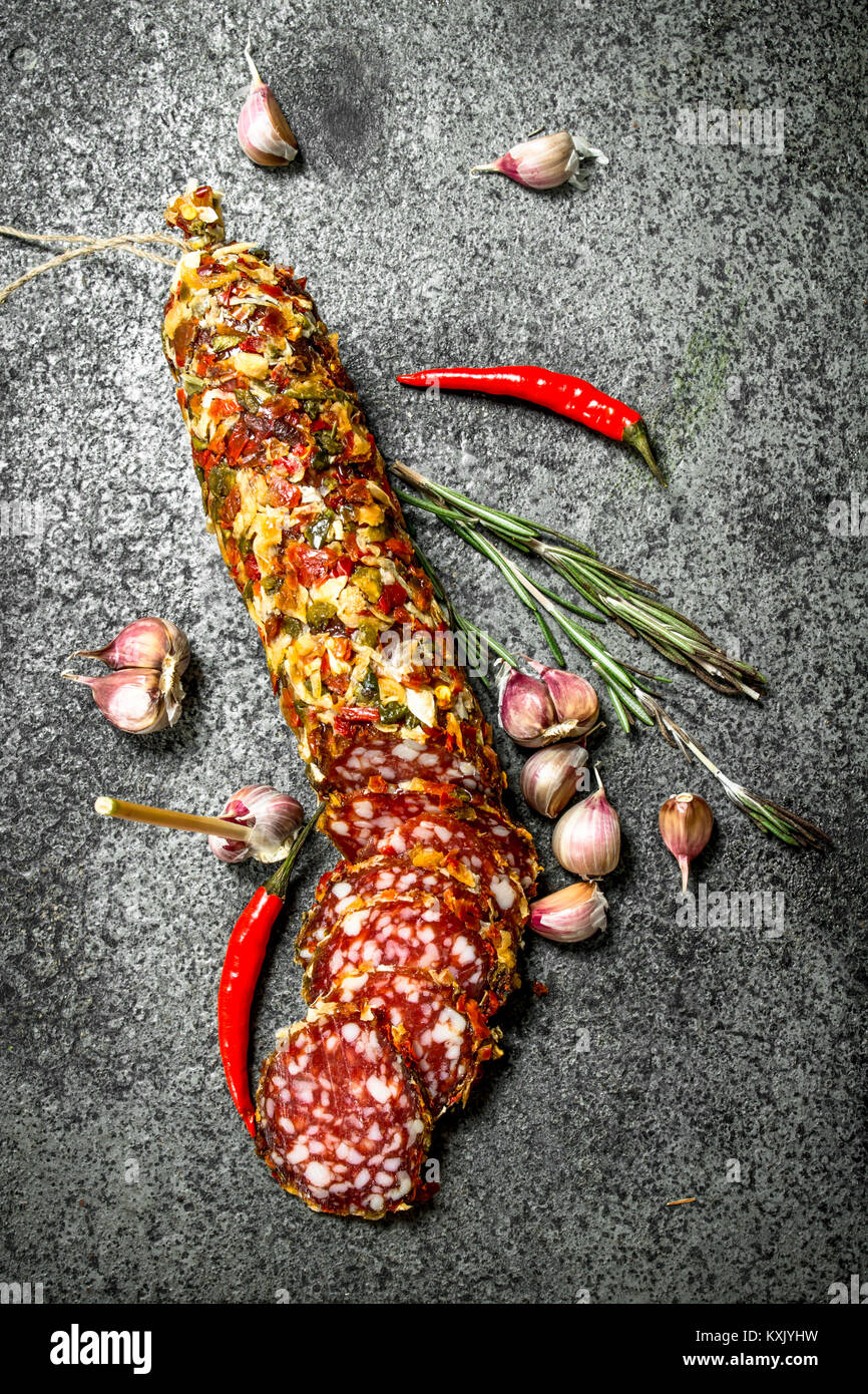 Salami with spices and herbs. On a rustic background Stock Photo - Alamy