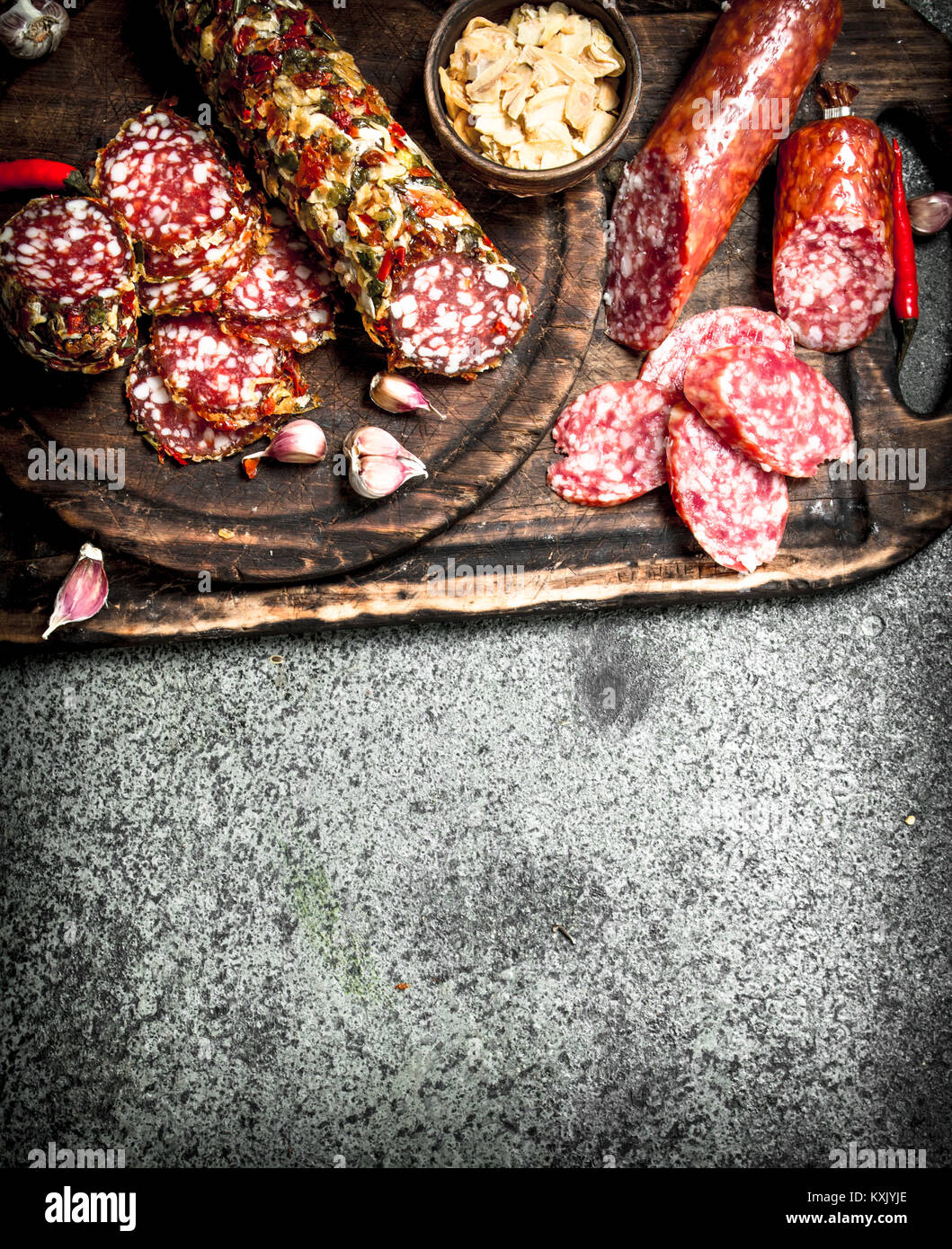 variety of salami with spices and herbs. On a rustic background Stock ...