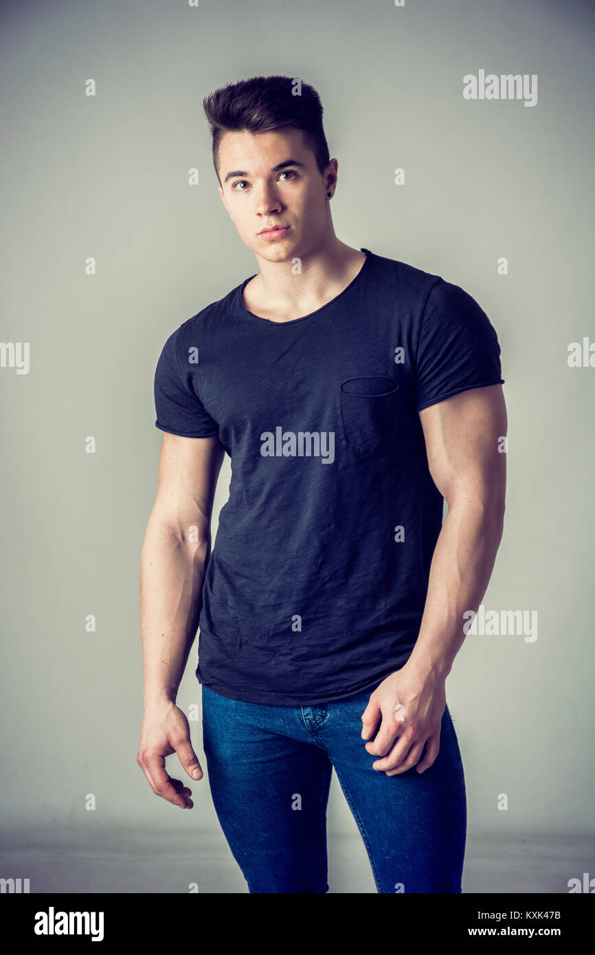 Handsome young muscular man looking at camera Stock Photo - Alamy