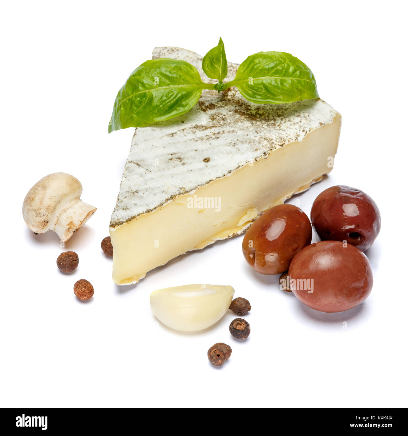 traditional french brie cheese, olives and mushroom on a white