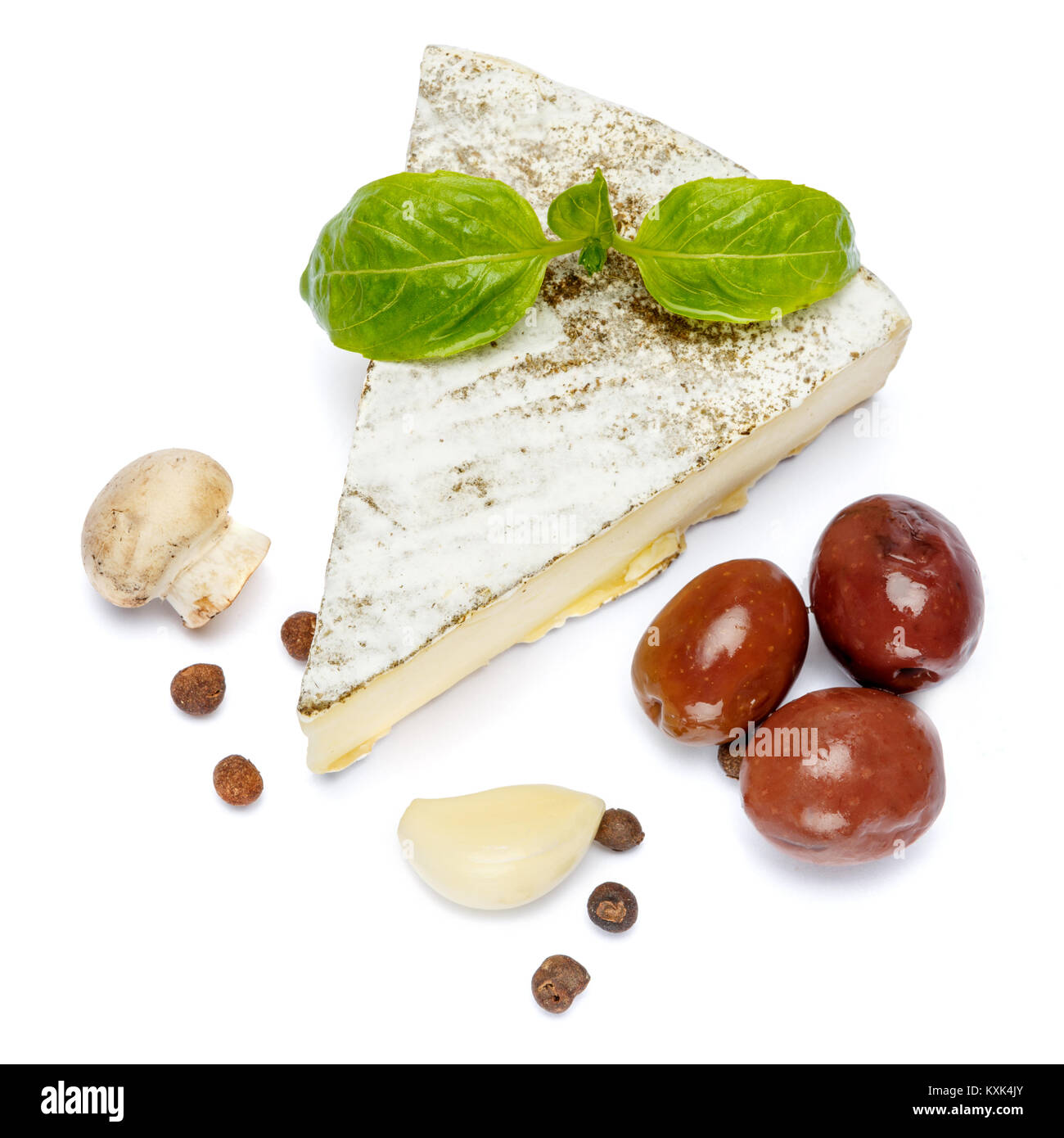 traditional french brie cheese, olives and mushroom on a white