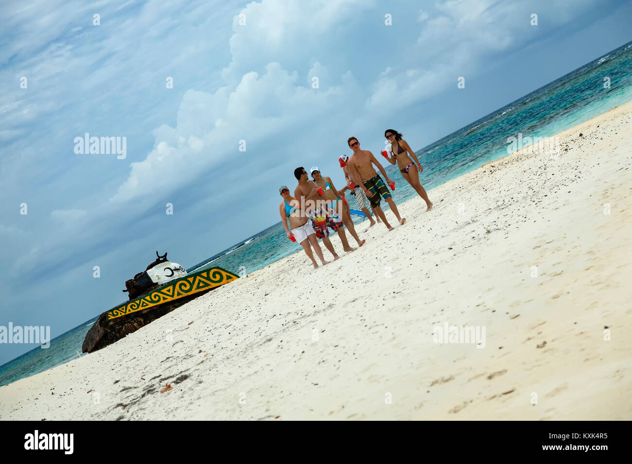 Group of young people walking near abandoned tank, Flamenco Beach, Culebra, Puerto Rico Stock Photo