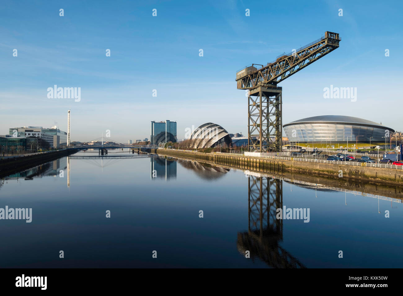 View of Finnieston Crane, SEC Armadillo and SEE Hydro arena beside River Clyde on blue sky winter day, Scotland, United Kingdom Stock Photo