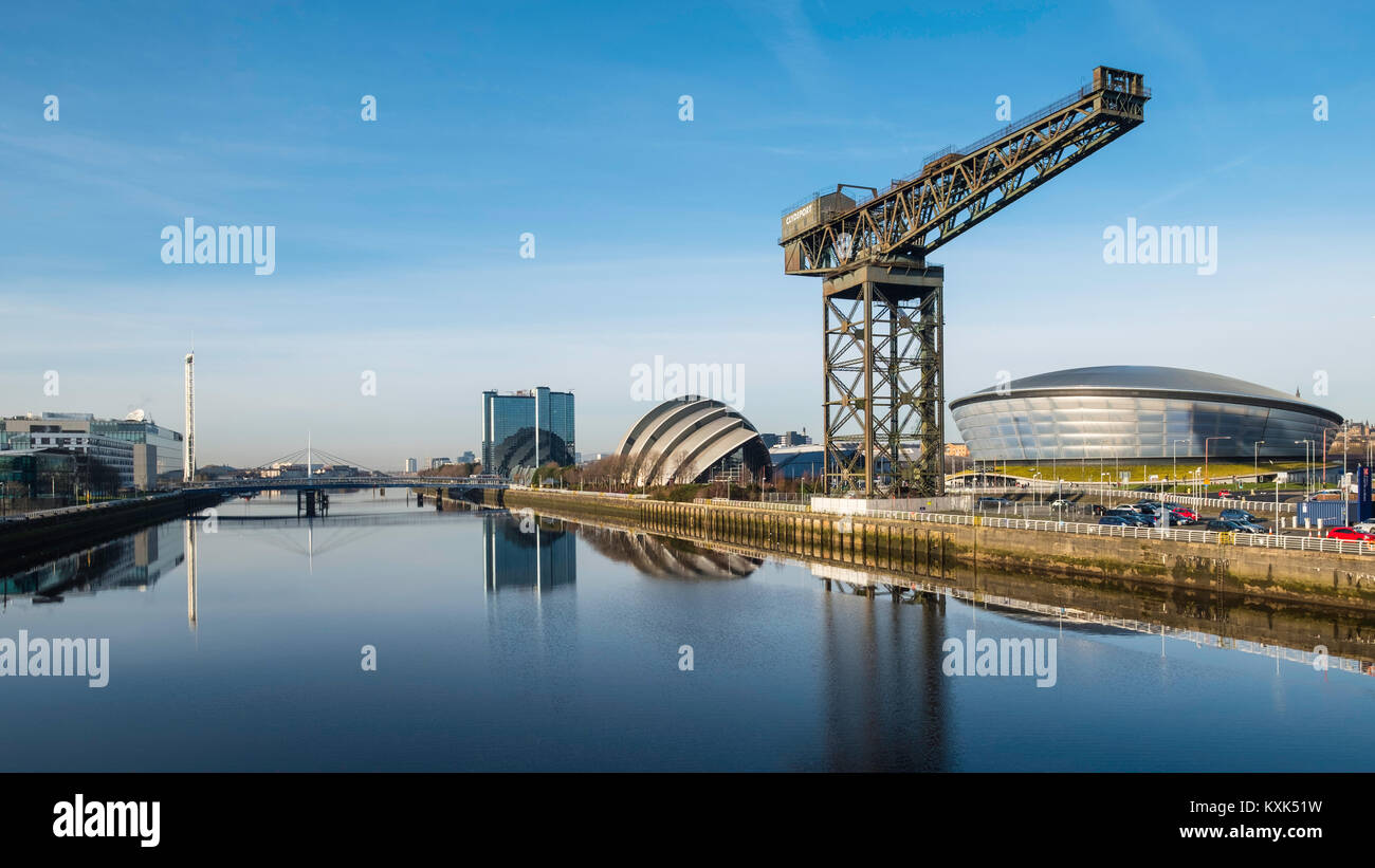 View of Finnieston Crane, SEC Armadillo and SEE Hydro arena beside River Clyde on blue sky winter day, Scotland, United Kingdom Stock Photo