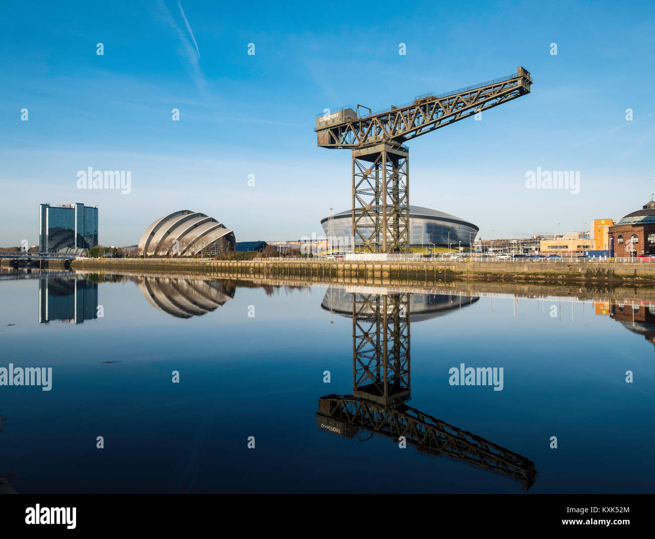 View of Finnieston Crane, SEC Armadillo and SEE Hydro arena beside River Clyde on blue sky winter day, Scotland, United Kingdom Stock Photo