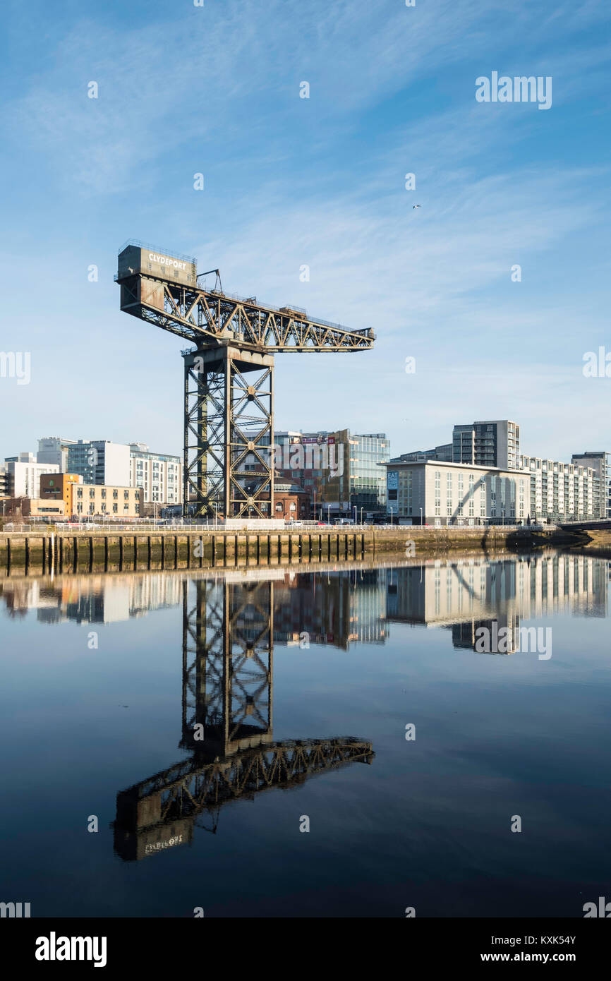 View of Finnieston Crane beside River Clyde on blue sky winter day, Scotland, United Kingdom Stock Photo