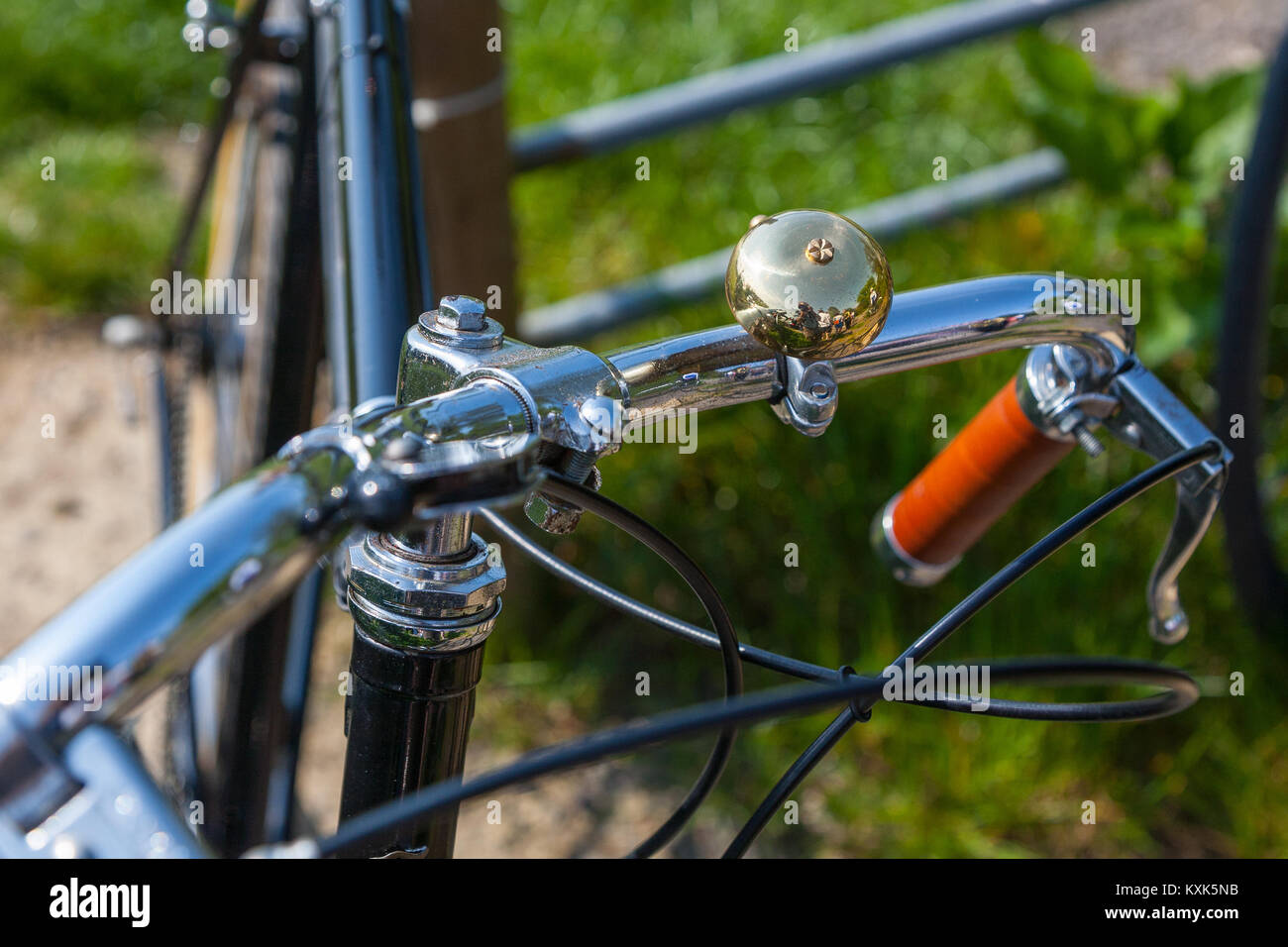 A close-up of a vintage bicycle chrome handle bars with a polished bell Stock Photo