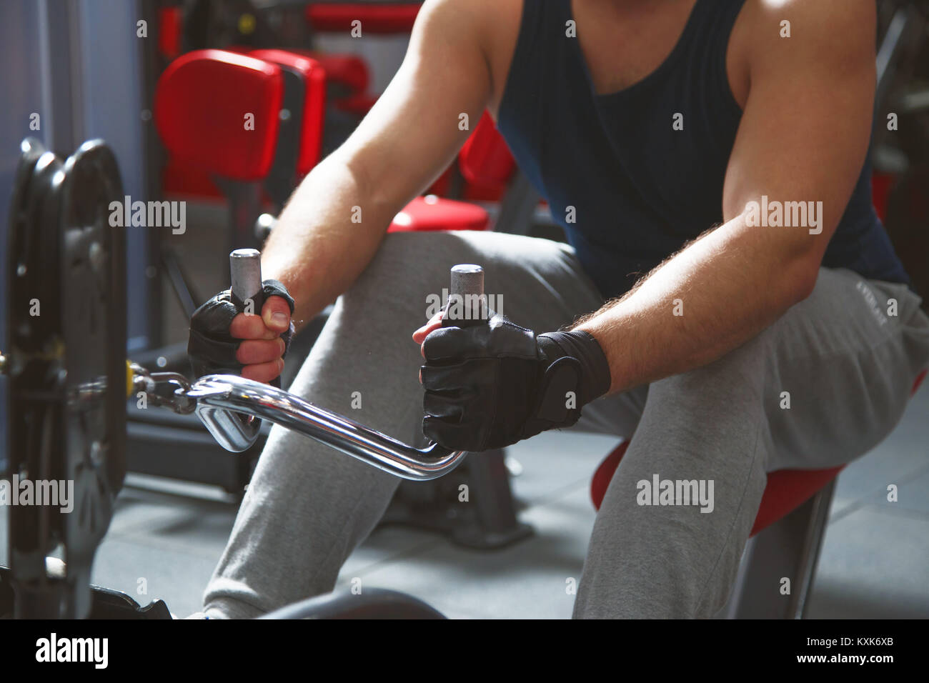 Rowing young man in gym training hands close up Stock Photo